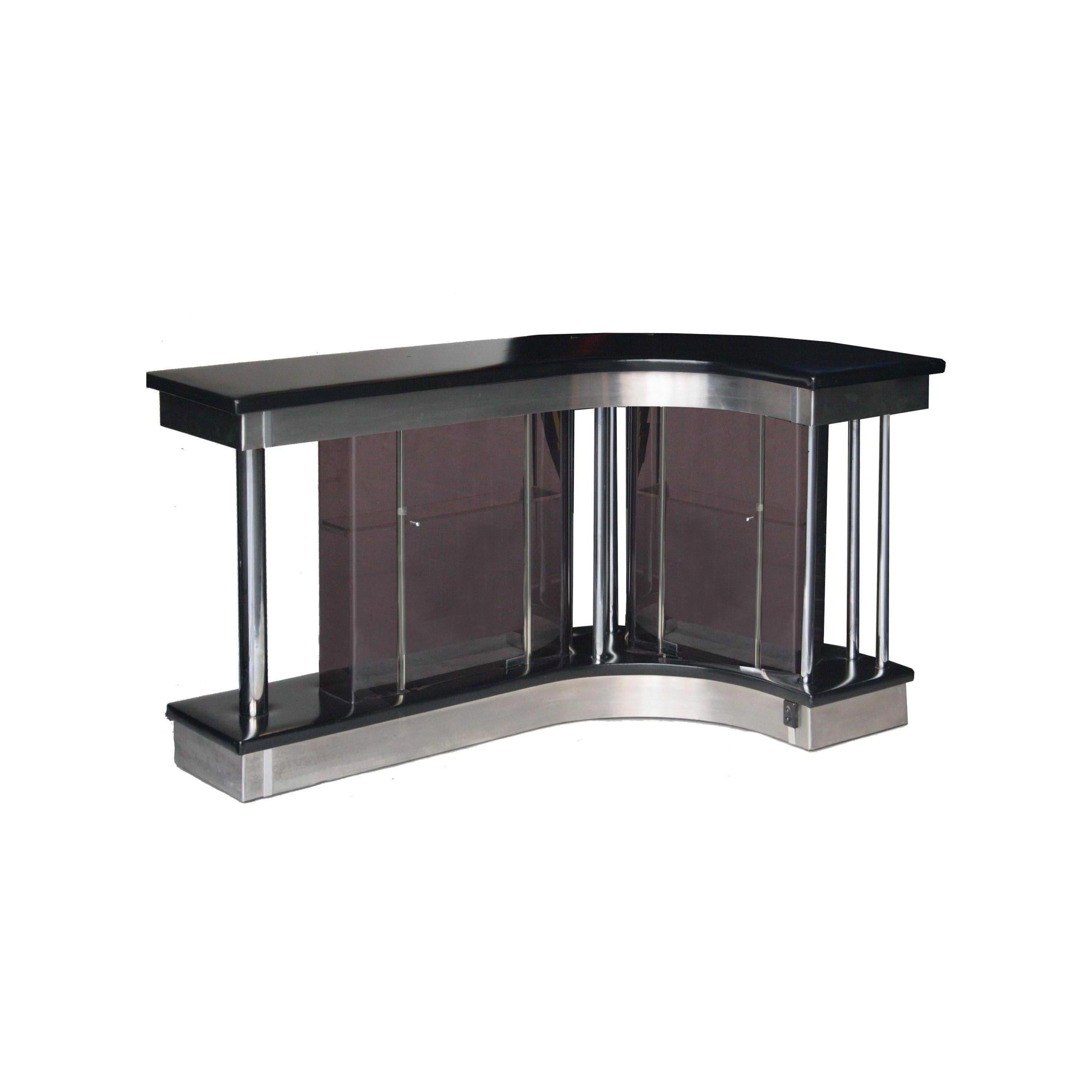 Bar set wooden structure with details in chromed steel and perplex screens. On black leather upholstery and backlit and inner bottle rack.