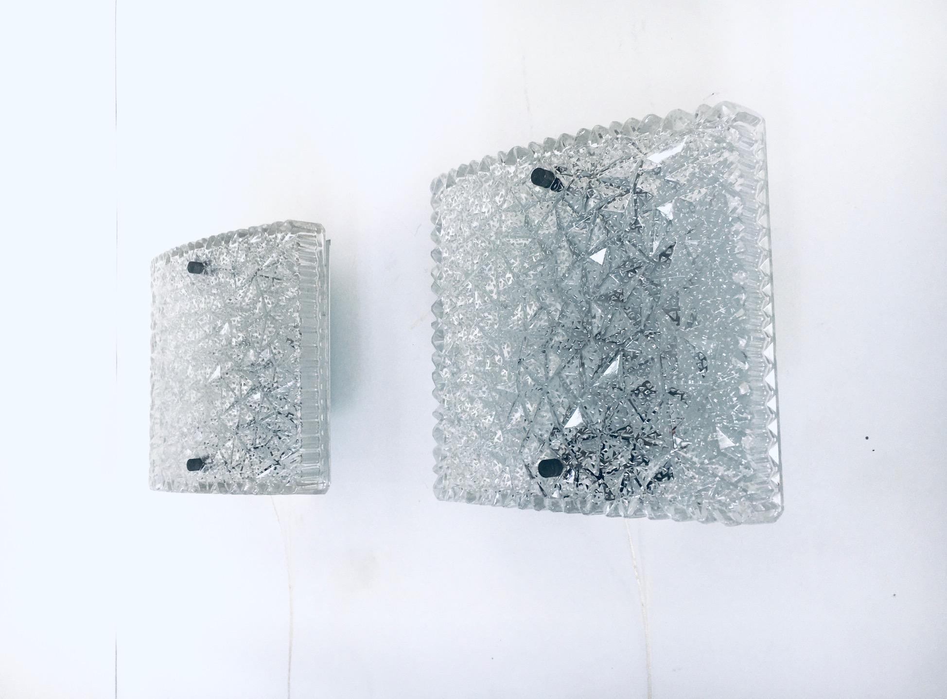 Vintage Mid-Century Modern design glass sconce wall lamp set of 2 by BUR Leuchten. Made in West Germany, 1960's / 70's. Raised square ice structured pressed glass on metal and plastic base with pull cord mechanism. In very good condition. Each lamp