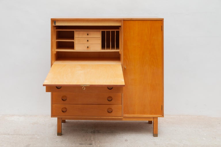 Vintage Mid-Century Modern desk sideboard, bureau secretaire.The honey-colored sideboard desk has been made of an ash veneer wood and brass feet. It contains plenty of storage space an open storage space with an integrated filing desk to organize