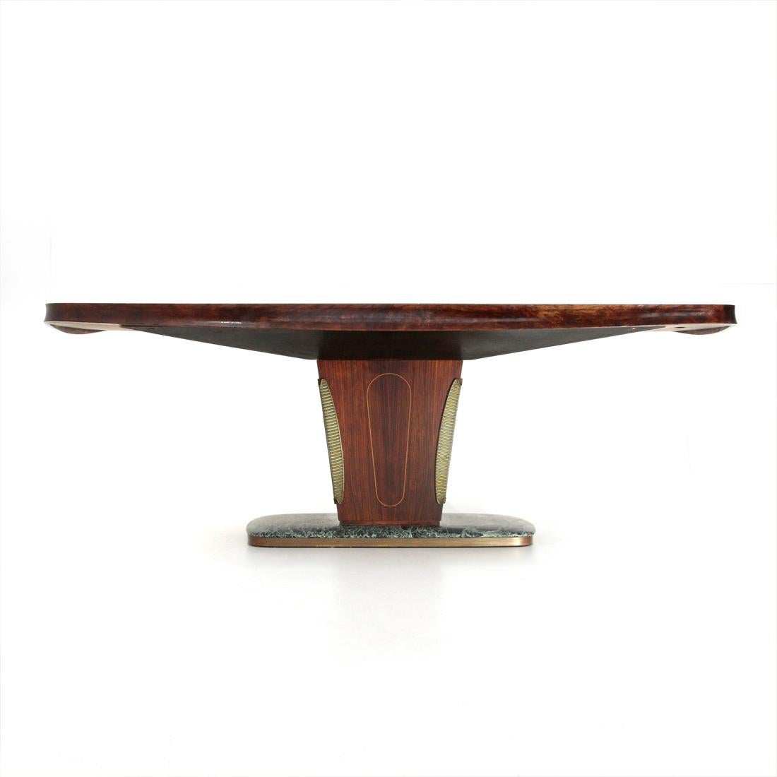 Dining table produced in the 1950s and designed by Vittorio Dassi.
Marble base with brass edge.
Central leg in veneered wood with edges covered in shaped and gilded wood.
Wooden top with curved wooden frame and green glass surface.
Good general