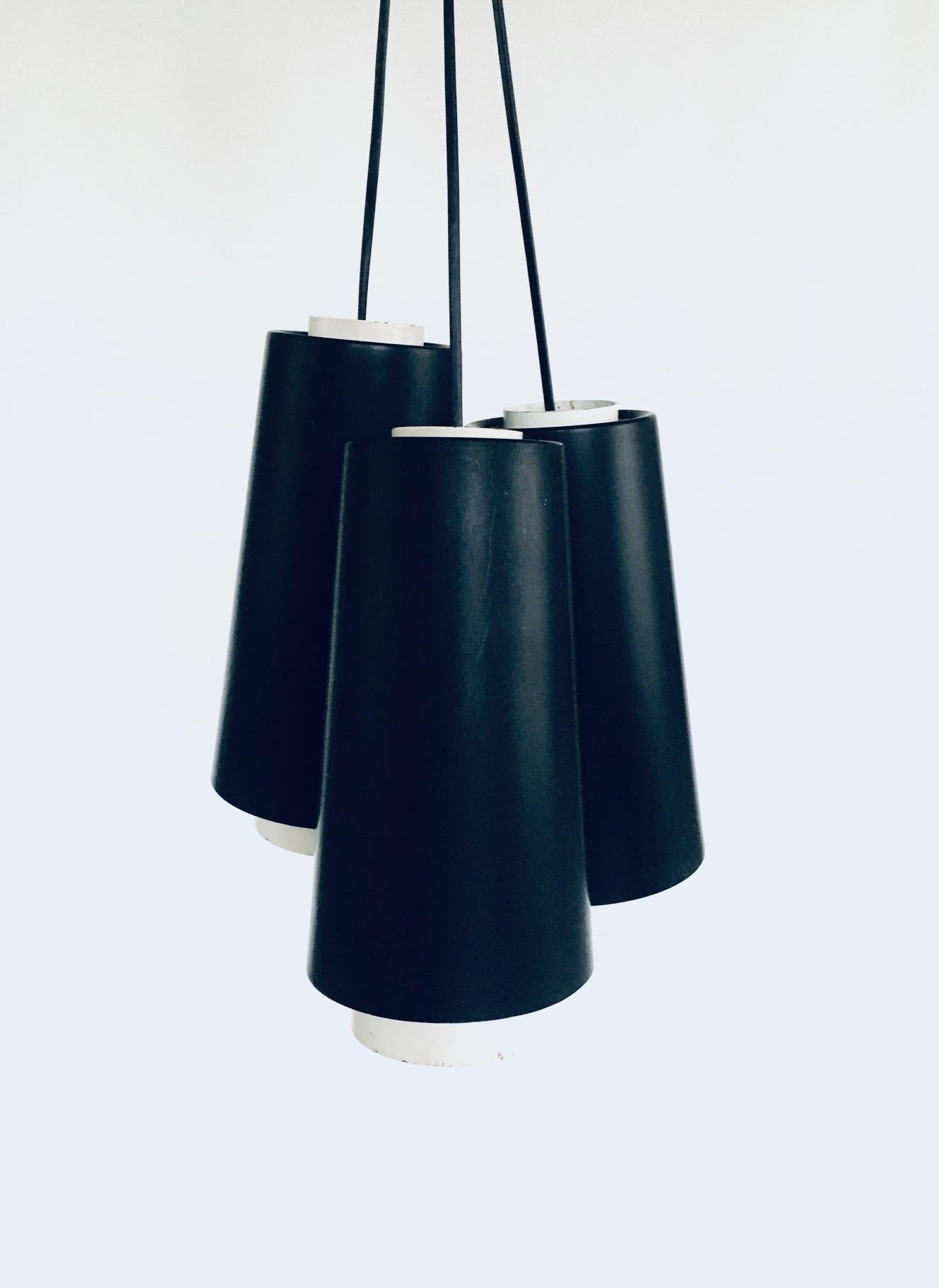 Vintage Mid-Century Modern Dutch Design 3 Pendant Lamps by RAAK Amsterdam, Holland 1960's. 3 Hanging lamps in black and white metal. Set up as one pendant lamp. All 3 lamps are in good condition with minor corrosion on the white metal parts. Black
