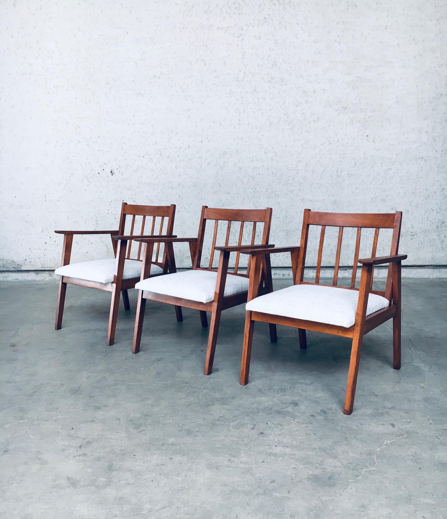 Vintage Mid-Century Modern Dutch Design armchair set, made in the Netherlands 1950's. Beech wooden frame, stained in teak color with wool fabric covered seat. The 3 side chairs have been restained with new reupholstered seats on the all original