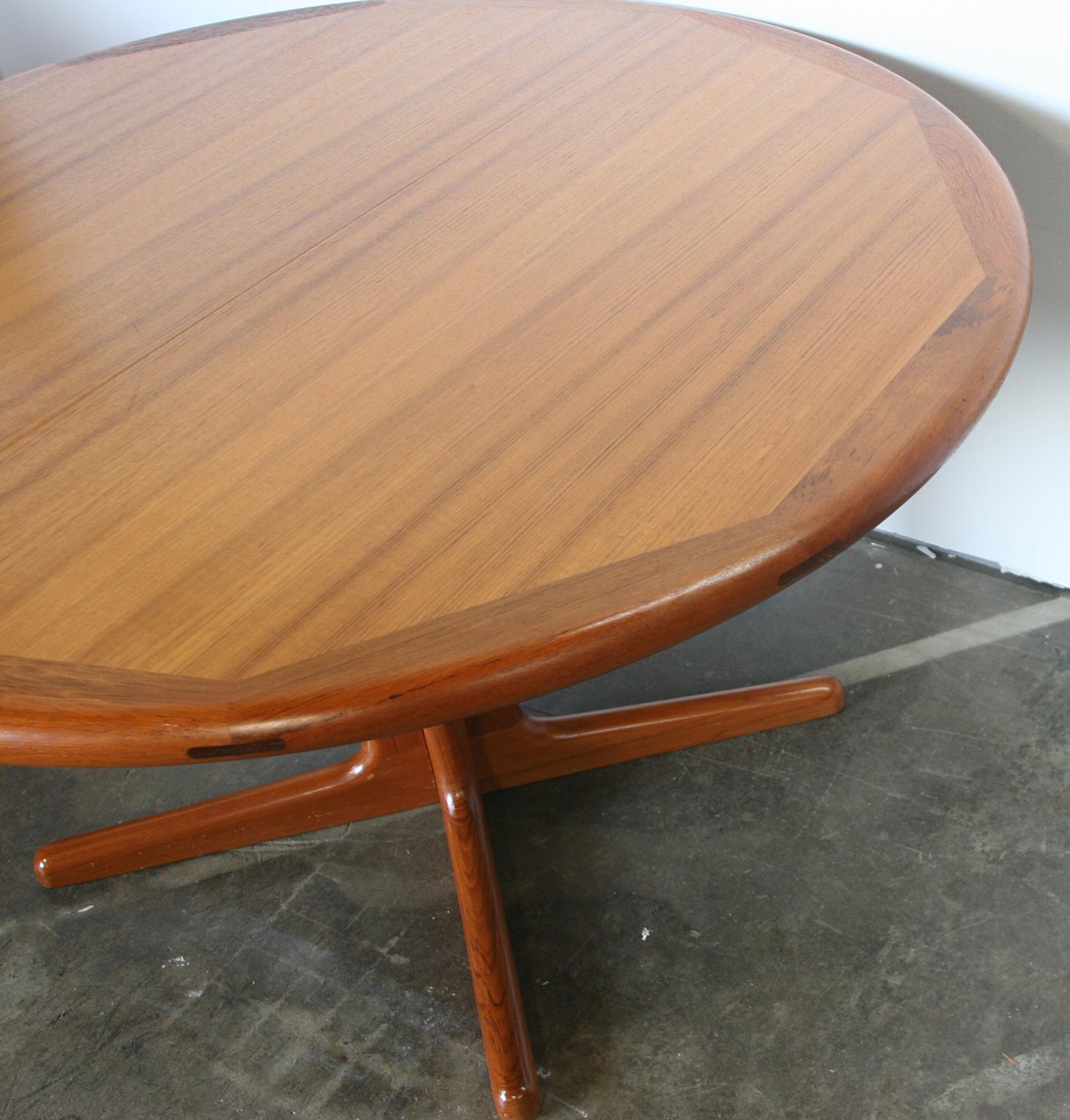 Midcentury Edward Valentinsen Teak Expandable sculptural round dining table with 2 leaves. This is a Beautiful table set Made in Denmark by Funiturefactory Ringe. Amazing rosewood details in rounded edge of table. Made circa 1960 all teak with solid