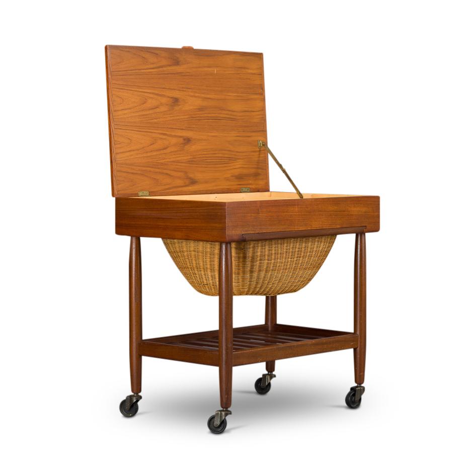 Ejvind Johannson designed this sewing cart for two factories. Both FDB Møbler and Vitre have produced this sewing cart in several different wood types like rosewood, teak and oak. Most of us know Ejvind Johannson for his famous eye chair #84.

The