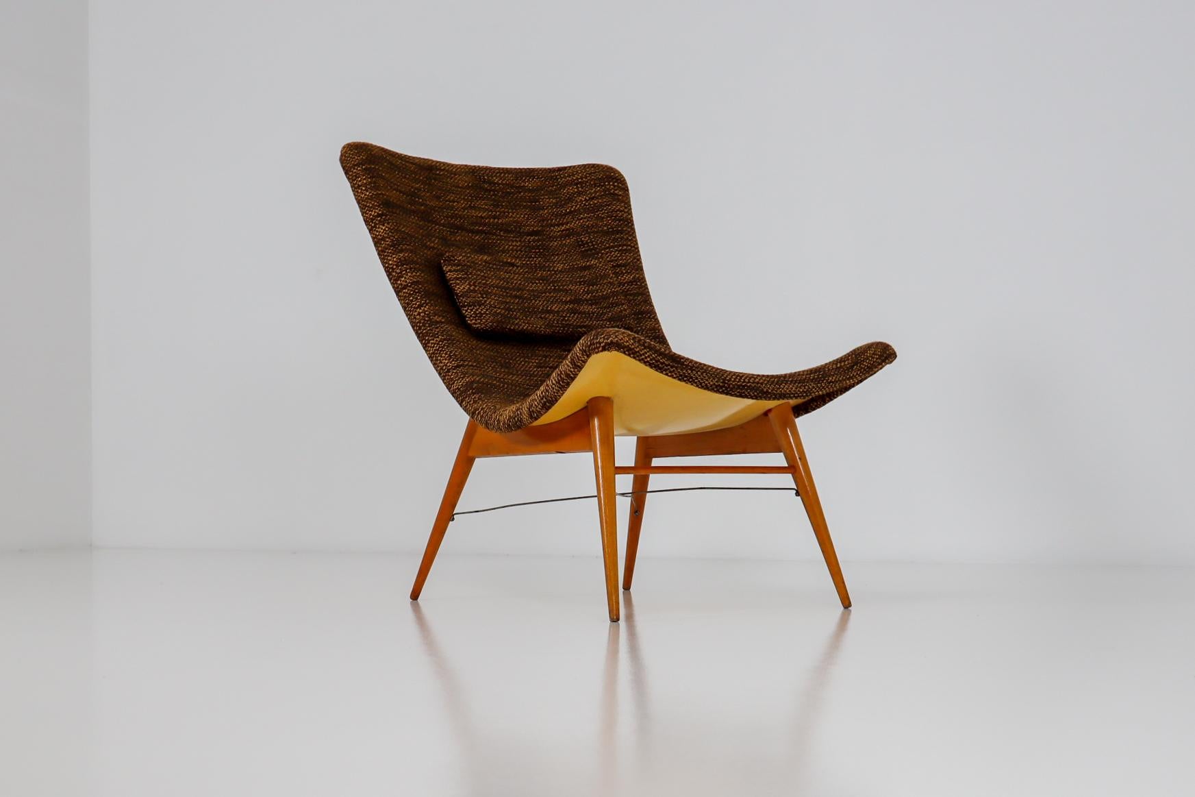 Lounge chairs by Miroslav Navratil, manufactured in former Czechoslovakia by Cesky Nabytek, 1959. Original wooden base, fiberglass shell seating. The backside of the chair is original yellow color and have a new Reupholstered fabric in brown color.