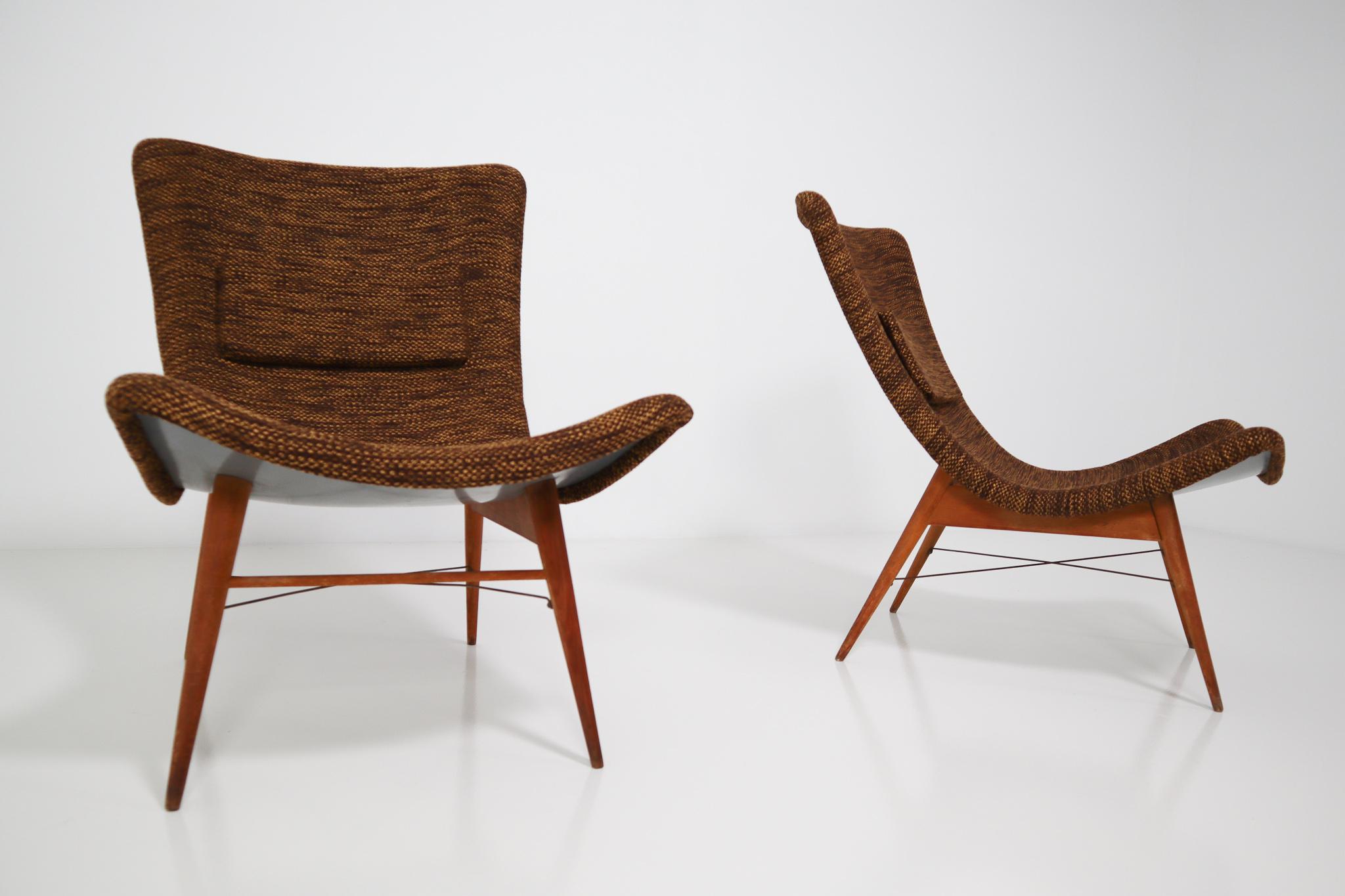 Lounge chairs by Miroslav Navratil, manufactured in former Czechoslovakia by Cesky Nabytek, 1959. Original wooden base, fiberglass shell seating. The backside of the chair is original grey color and have a new Reupholstered fabric in brown color.