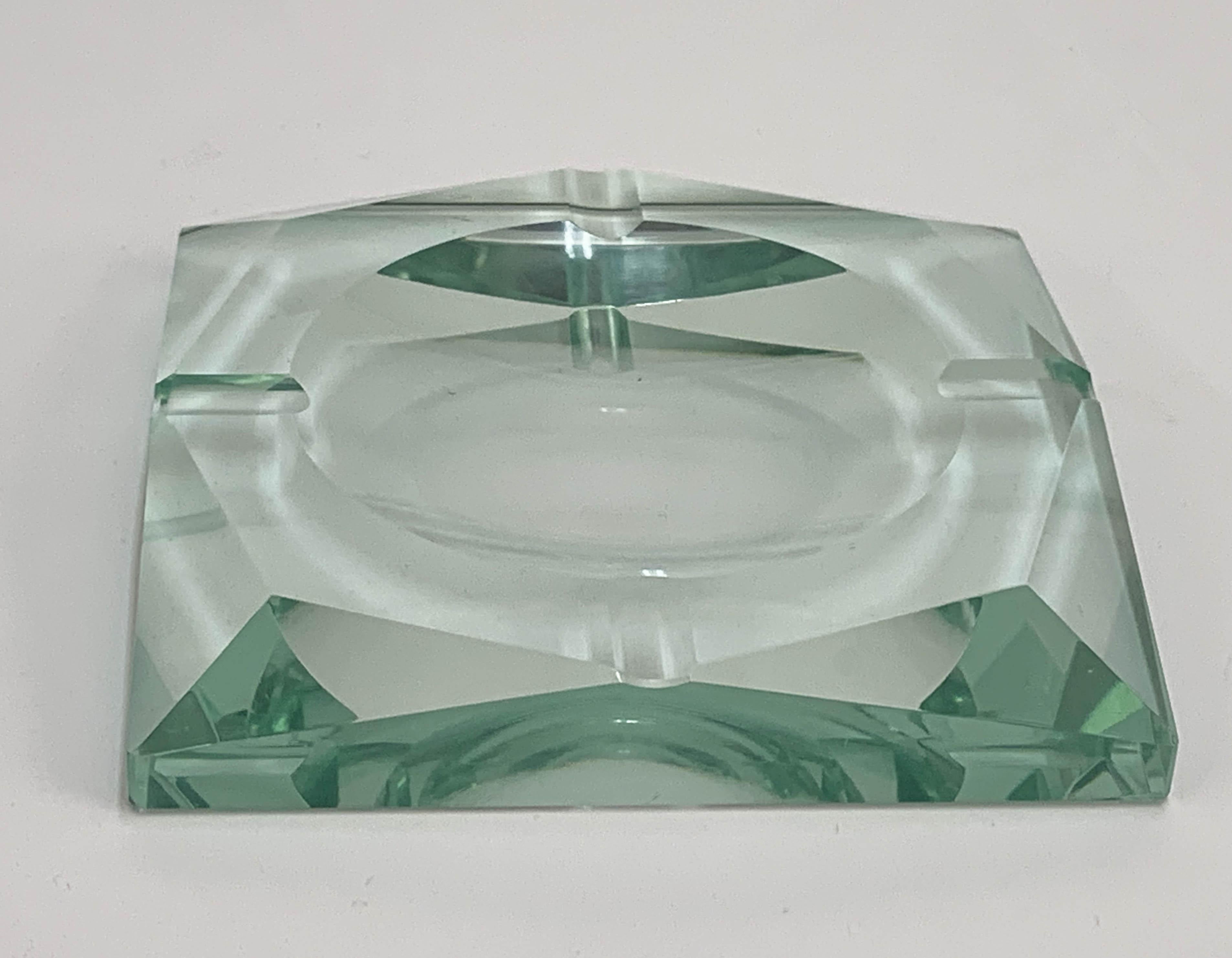 Amazing Mid-Century Modern green glass squared ashtray. This wonderful piece was produced by Fontana Arte in Italy during 1960s.

The item is in squared green glass with geometrical carving, a Classic design by Fontana Arte from the 1960s.

This