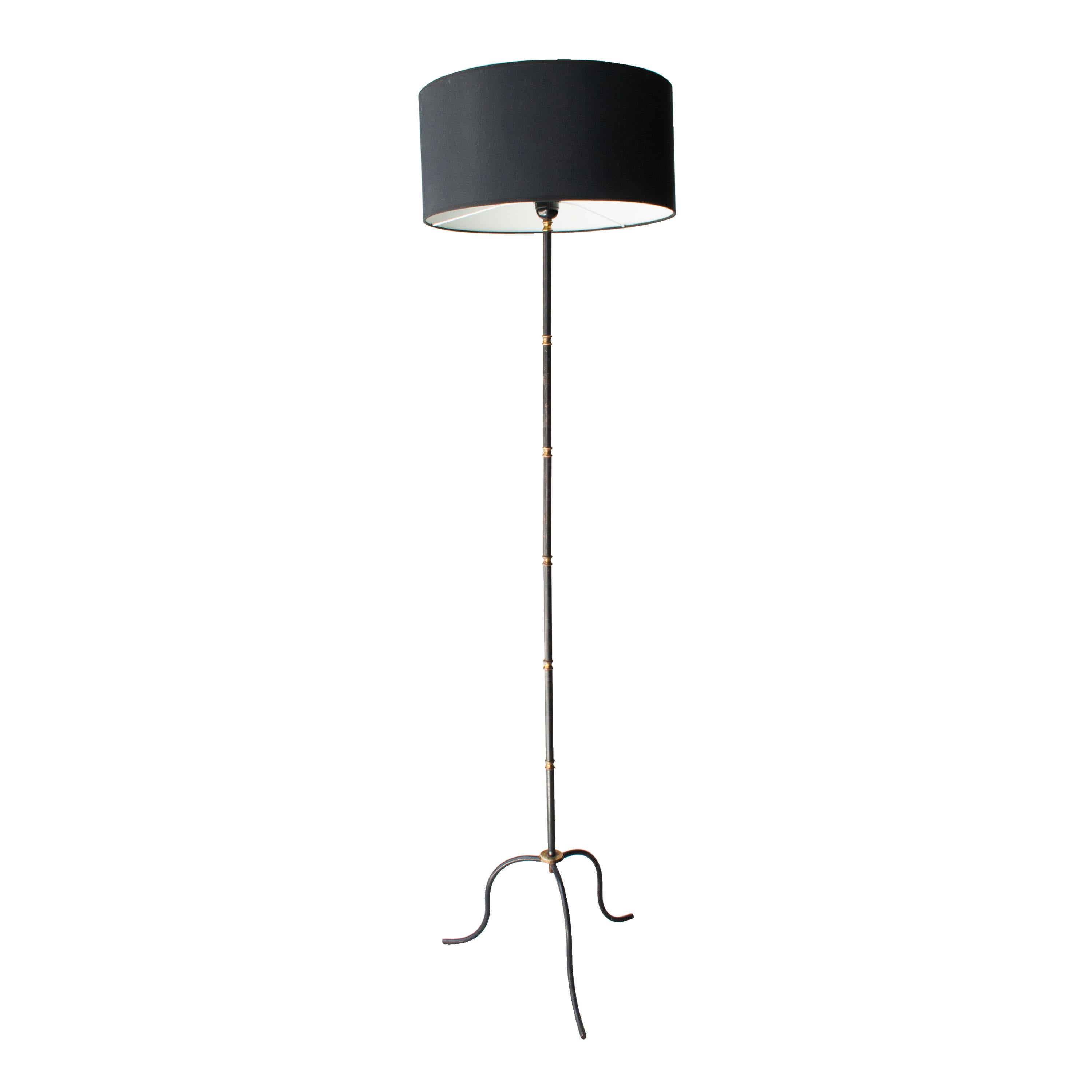 Floor lamp made in forge with brass details and screen made in black Chintz.