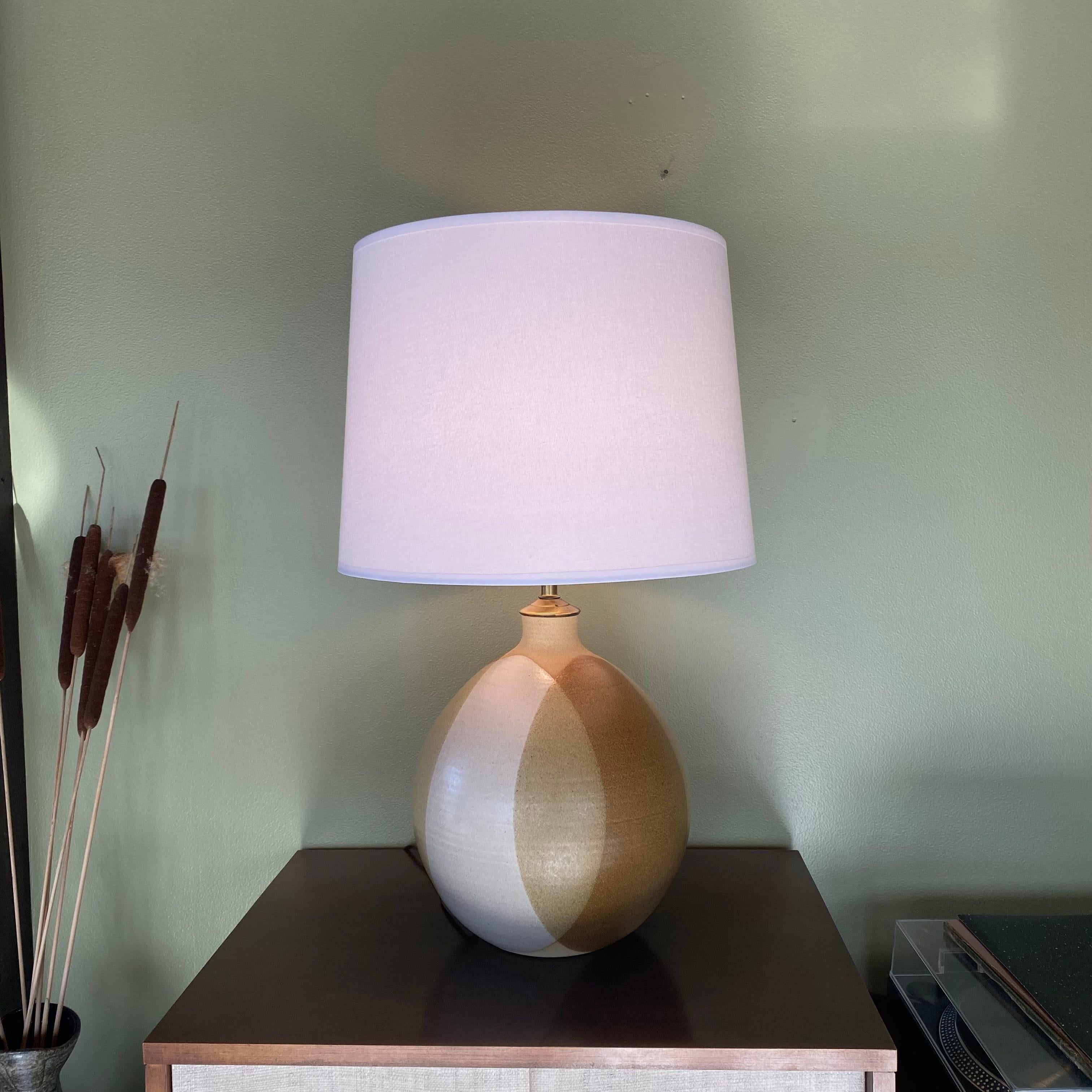 This is a beautiful round sphere handmade ceramic glazed table lamp by Oregon ceramicists Larry and Terry Brown, signed “Brown” next to the cord hole on the bottom, ca. 1960’s. The lamp parts are made of brass, with a new 16” hardback empire shape