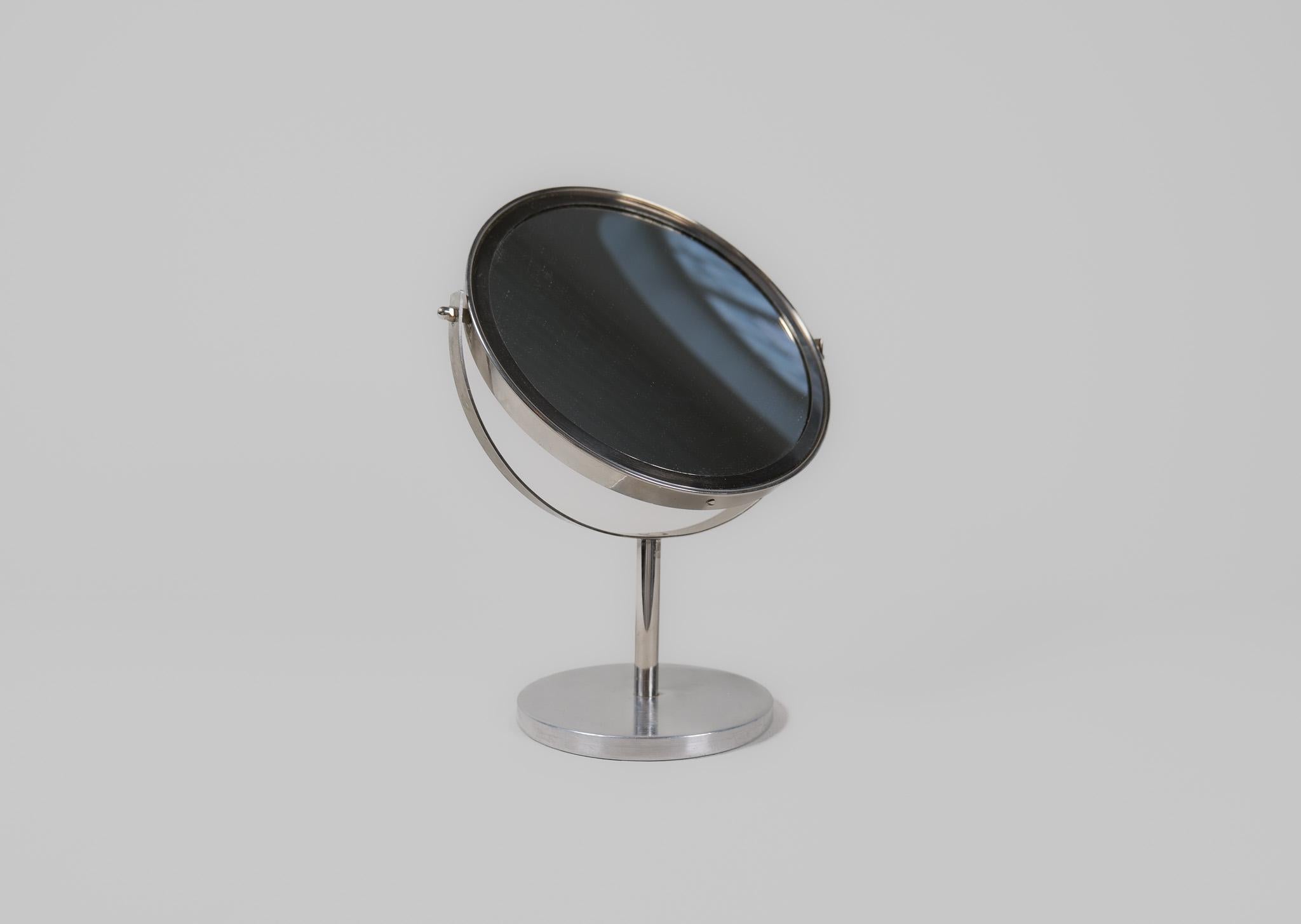 This midcentury table mirror in chrome was produced in Sweden at AB Markaryd and designed by Hans-Agne Jakobsson. This mirror has double mirrors where the small one works as a magnifier mirror. 

Good vintage condition with scratches and