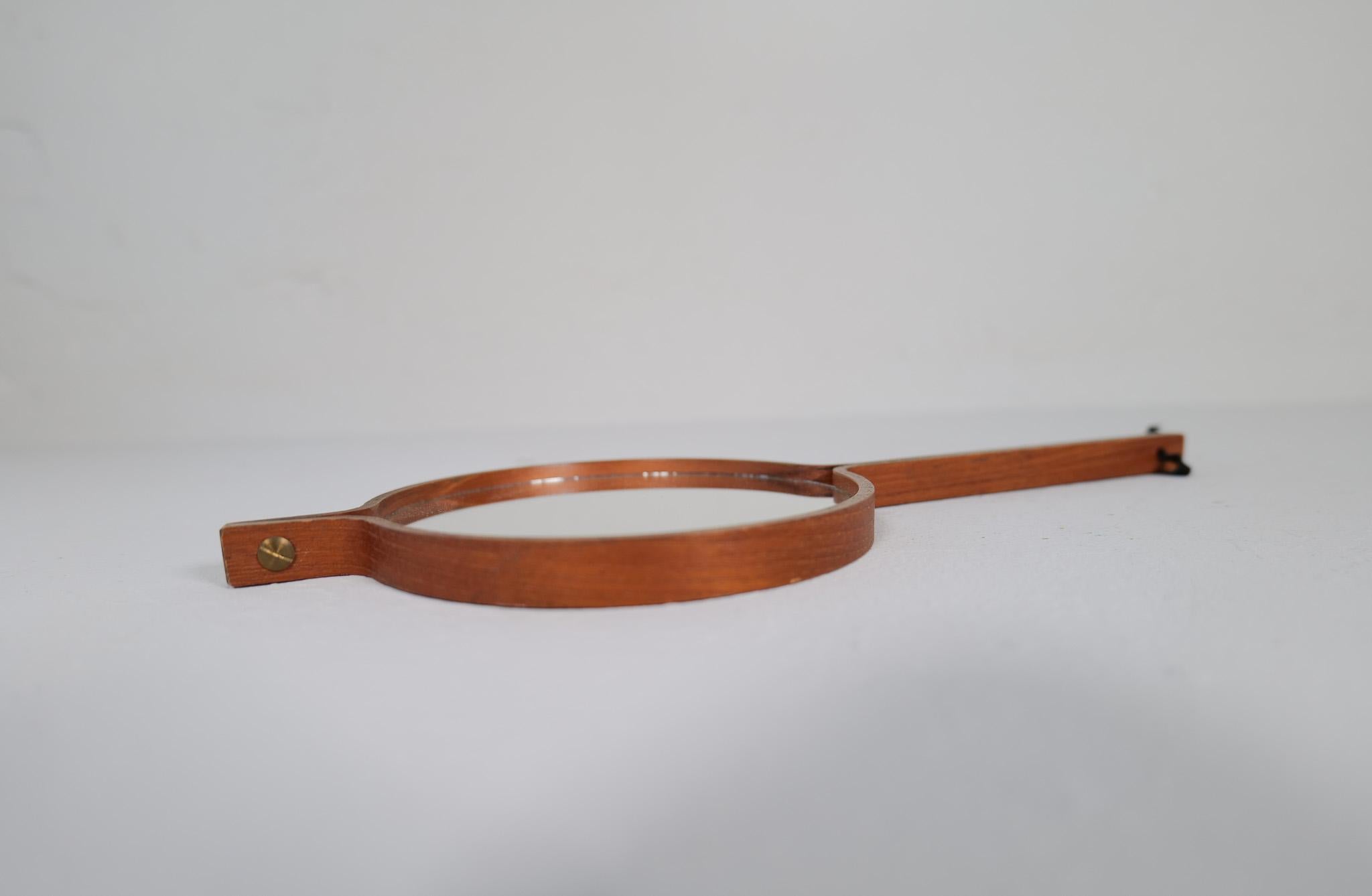 Questo specchio a mano di metà secolo in teak è stato prodotto in Svezia da AB Markaryd e progettato da Hans-Agne Jakobsson. Questo specchio è dotato di specchi su entrambe le estremità. Si monta facilmente alla parete come pezzo scultoreo. 

Buone