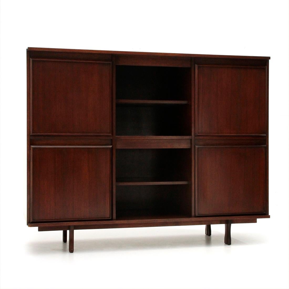 Sideboard produced by Stilwood in the 1960s based on a design by Giovanni Ausenda.
Structure in veneered wood.
Two central open compartments with shelf.
Side compartments with door, recessed handle and internal shelf.
Lower left compartment with