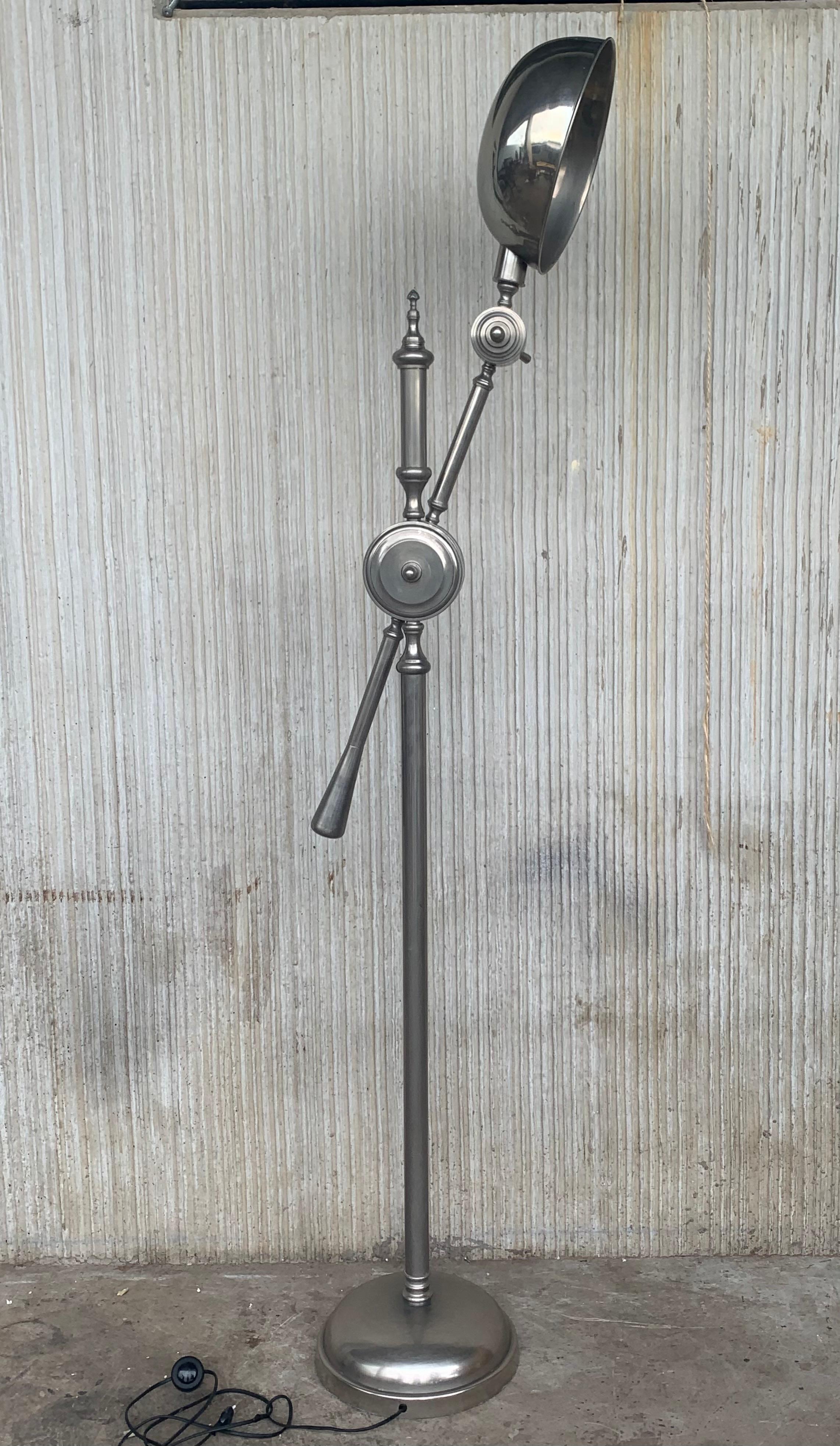 A substantial midcentury industrial lamp. An incredible piece with solid cast iron base, long chrome arm and fittings with a large polished aluminum head. This lamp is fully adjustable in all directions.
Incredible hardware to adjust the different