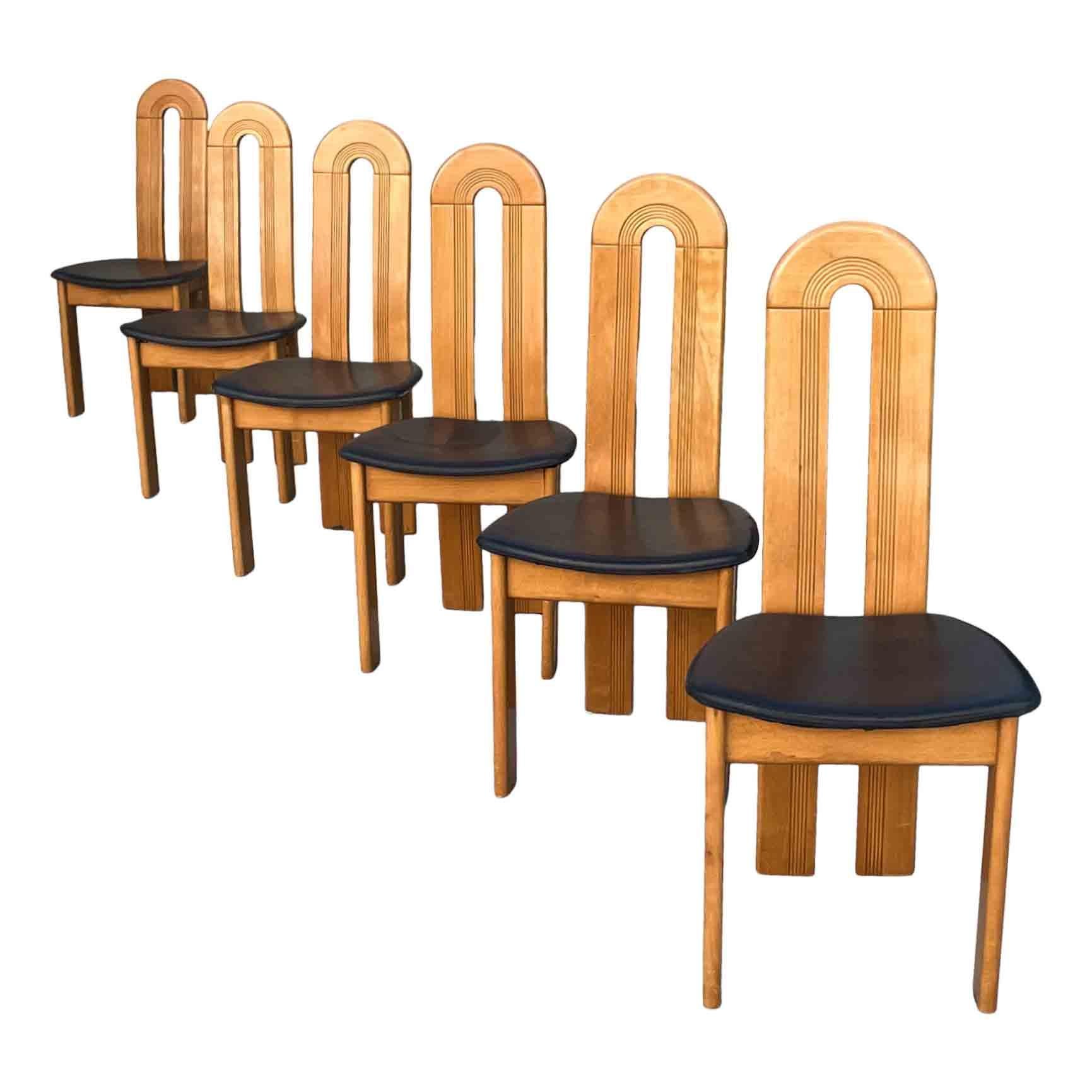Set of six Italian dining chairs, made in the late 80s.

They feature an ash wood structure and a black leather seat.

They remind the shapes Afra and Tobia Scarpa proposed before with “Africa” and Mario Marenco with “Sapporo” chairs.

Excellent
