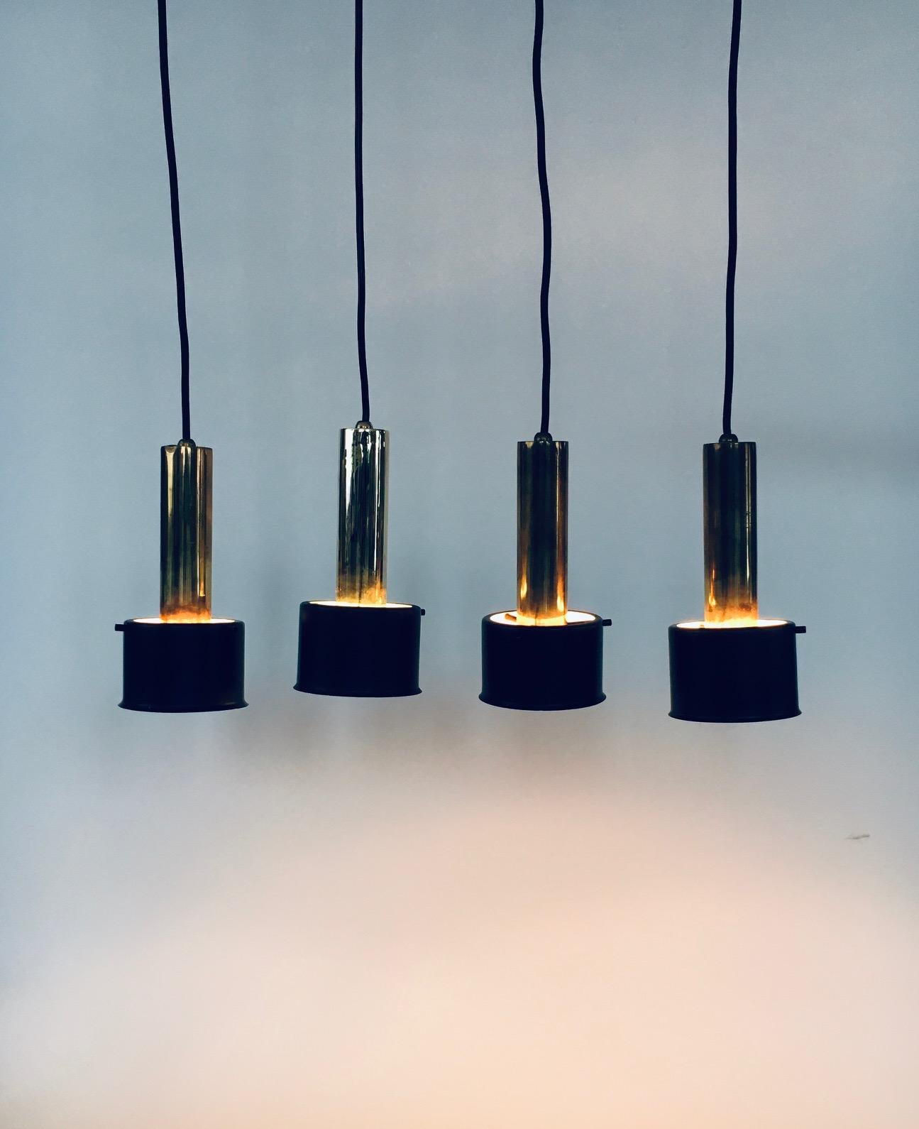 Vintage Midcentury Modern Italian Design Suspension Lamp set of 4. Fabriqué en Italie, 1960's. Attribué à Stilnovo. Non marqué. Ensemble de 4 lampes suspendues en laiton avec un abat-jour en métal noir. Design/One. Ils sont tous en bon état, avec