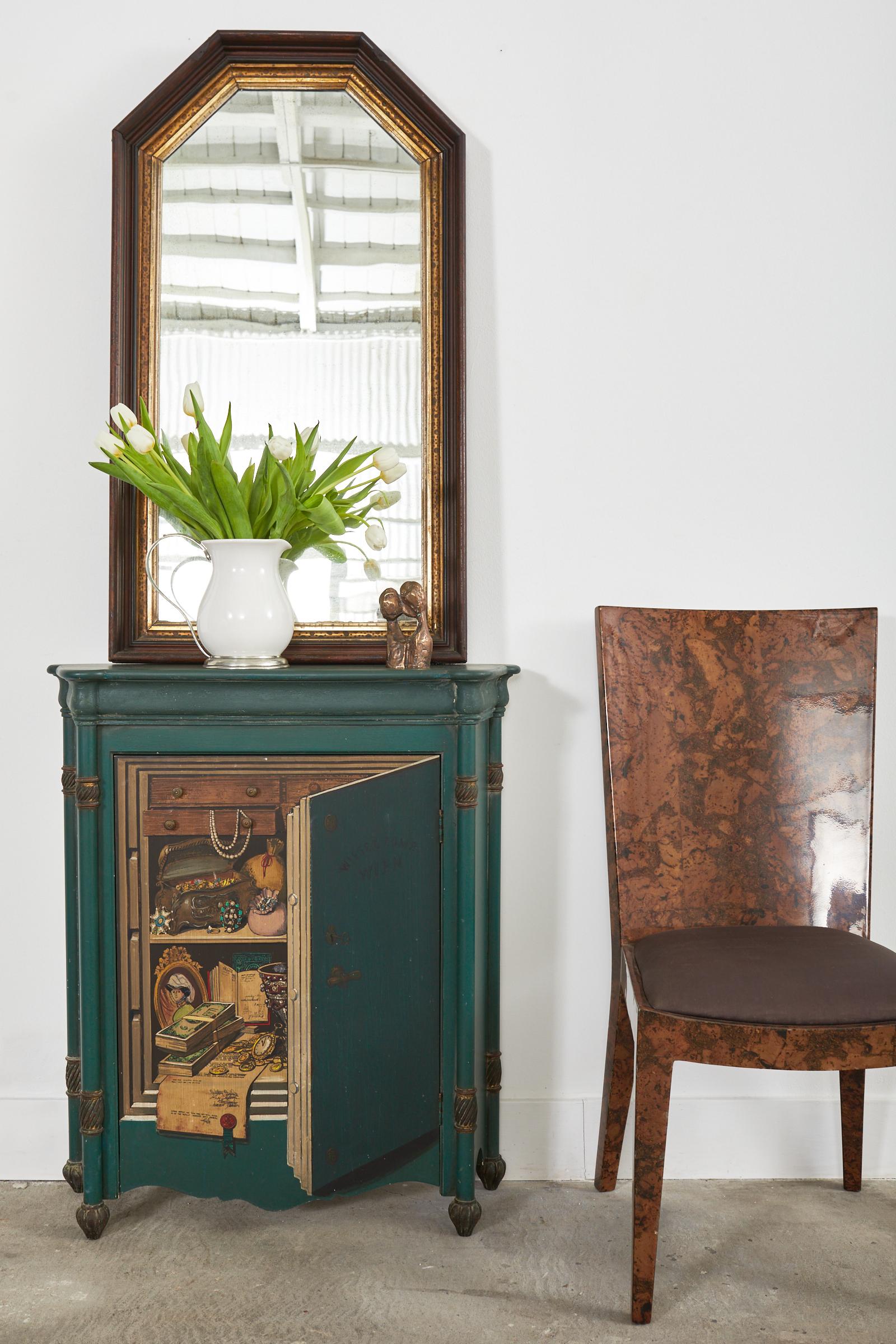 Fantastic mid-century modern Italian cabinet or bookcase made in the manner and style of Fornasetti by Palladio. The green painted wood cabinet features a case decorated to appear as a floor safe with an open front door. The whimsical painting