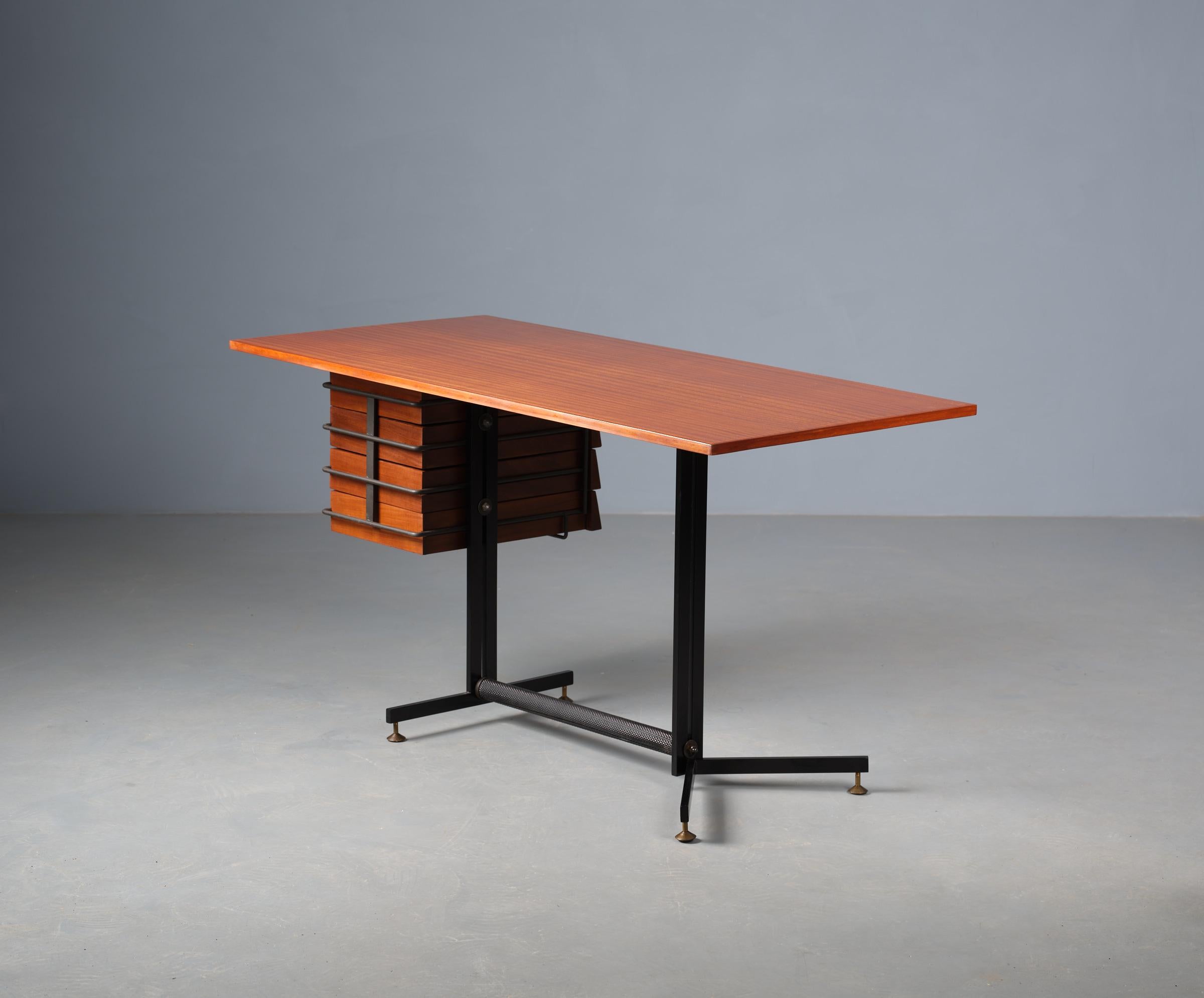 Restored vintage writing desk, originating from Italy in the 1950s, presents a striking example of midcentury design ethos. Crafted from rich teak wood and featuring a sleek frame of lacquered black iron with brass accents, this piece epitomizes the
