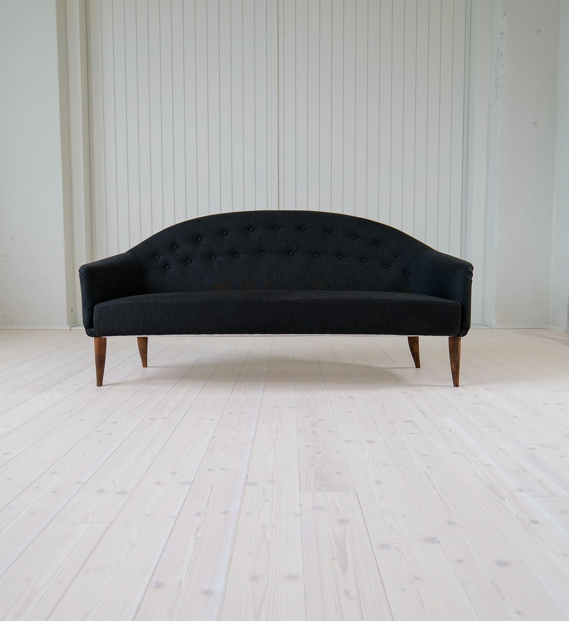 This three-seat sofa with elegant and sensual forms was named “Paradis” and was a series designed by Kerstin Hörlin-Holmquist for NK (Nordiska Kompaniet). Reupholstered with Swedish quality fabric and the birch legs are stained with a cognac-colored