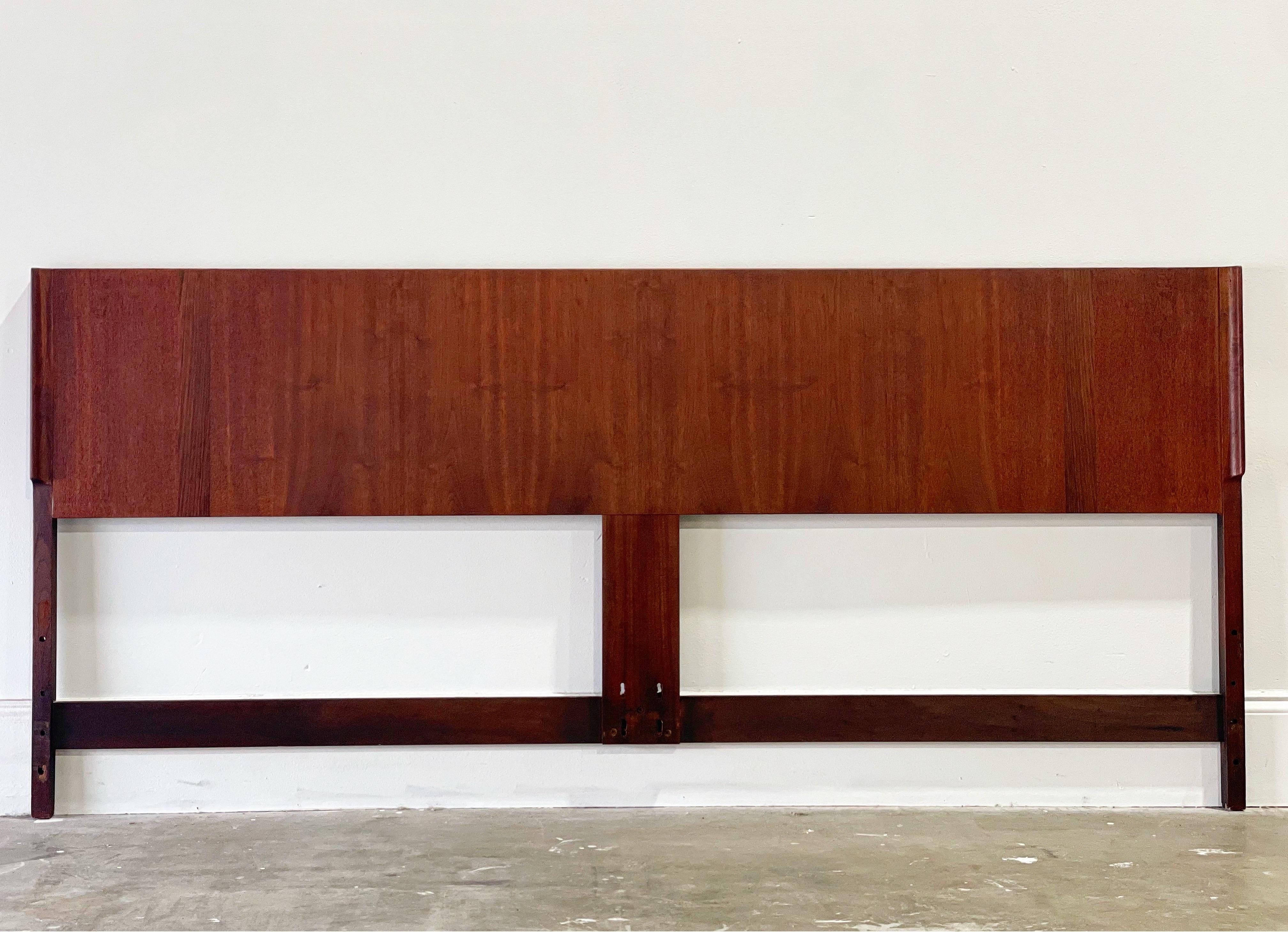 King size mid century walnut headboard with contrasting rosewood inlay by Jack Cartwright for Founders Furniture, circa 1961. Sleek and minimal Danish modern style with stout and sturdy American craftsmanship. Flared edge detail adds a sense of