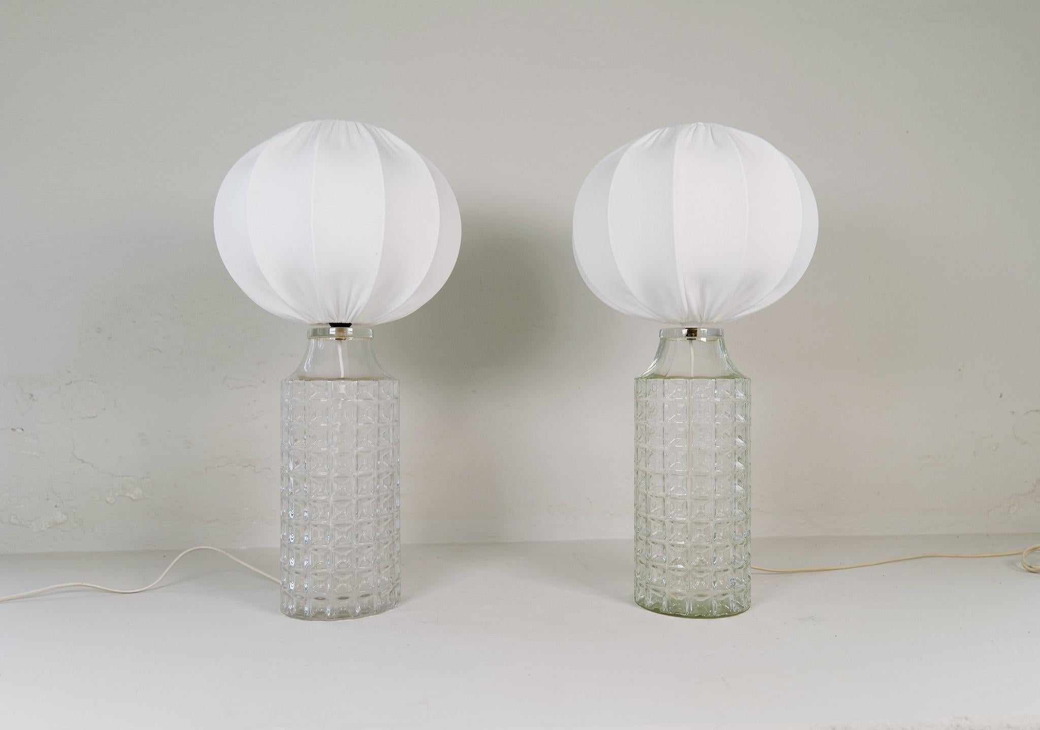 Midcentury large and rare modern table lamps design by Carl Fagerlund for Orrefors Glasbruk in Sweden.
The scuplural glass with an all-new cotton shades gives a great modern look. 

Good condition.

Dimensions: height: 23.6 in (60 cm), width: 7