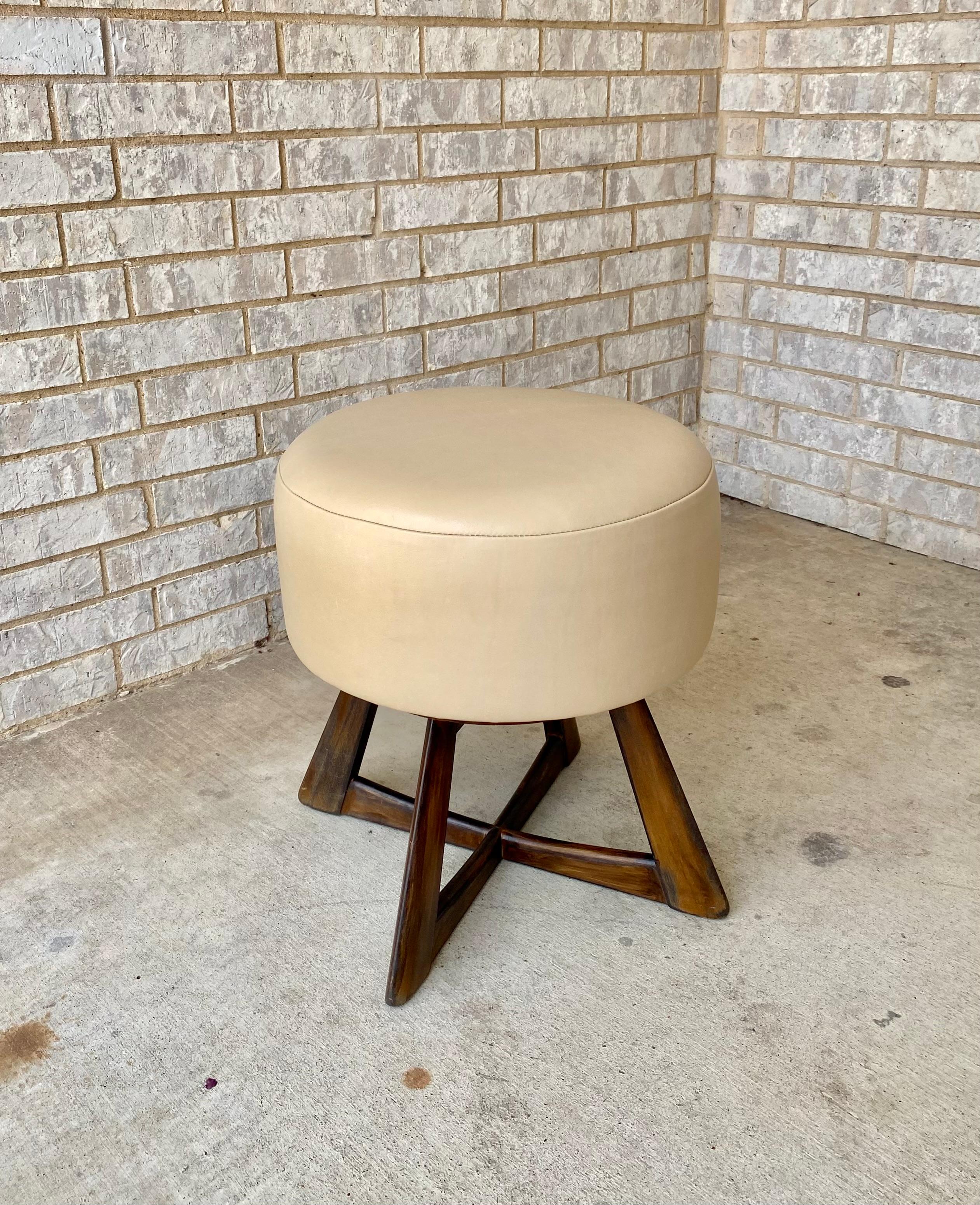Reimagined swivel stool by Heywood-Wakefield Co. An authentic Midcentury Modern piece brought into the 21st Century with a dark stain on the original sculptural base and buttery soft, highest quality, Grade A leather. All new foam and conditioned