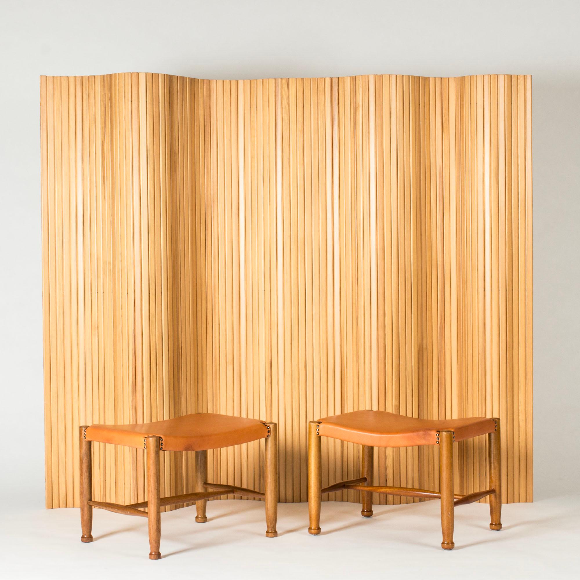 Pair of elegant stools by Josef Frank, made from mahogany with elegantly sculpted feet. Cognac brown leather with decorative nails around the joinery of the legs.