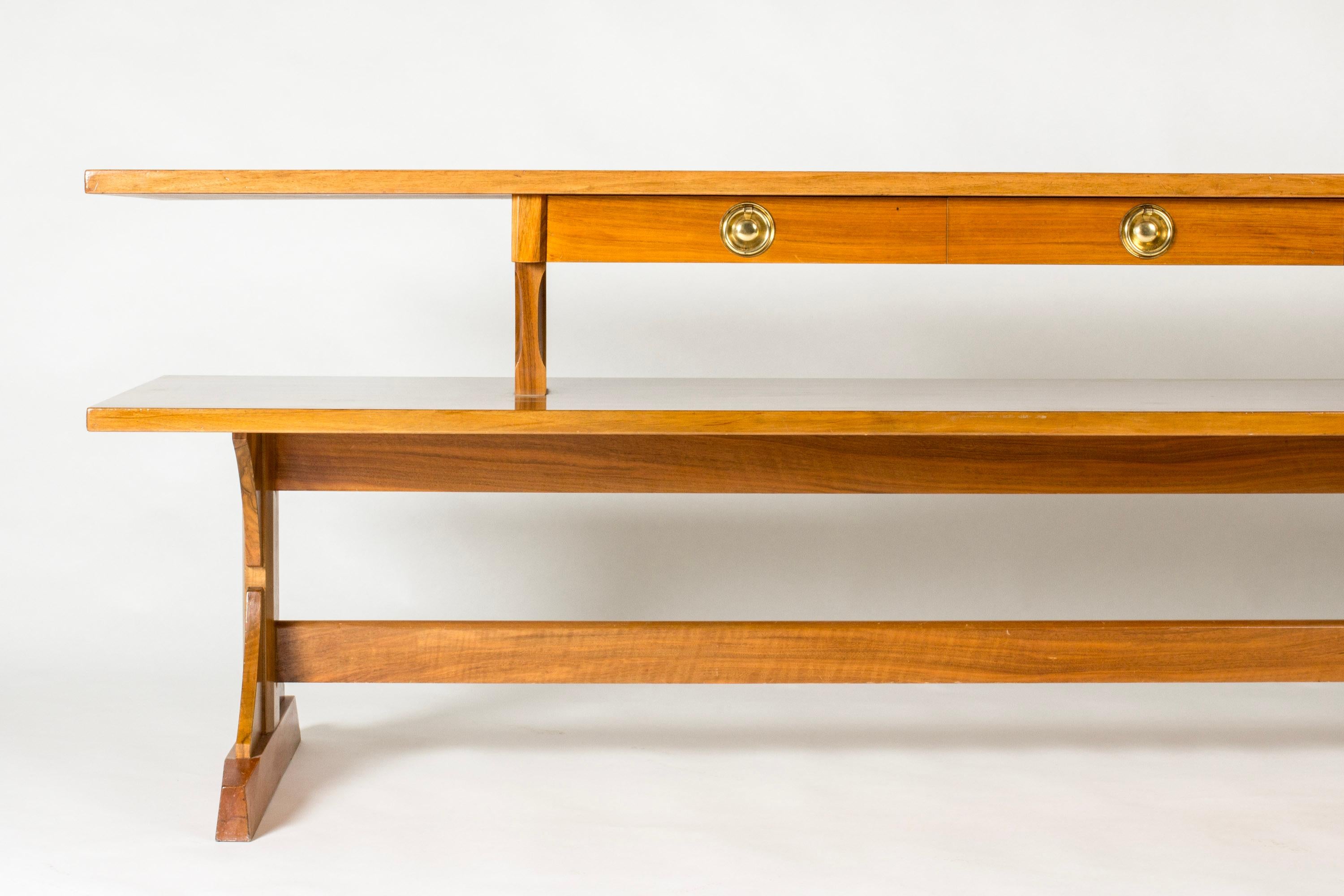 Striking library table or sideboard by Josef Frank, model 2226. Crafted from mahogany with brass drawer handles.