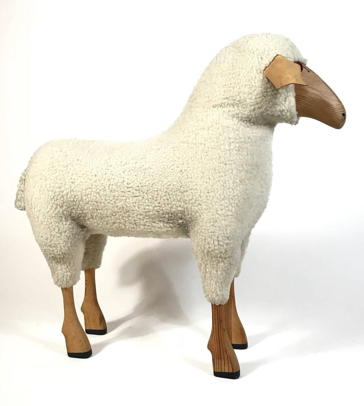Very decorative handmade lambswool sheep stool object from early 1970s. The handmade wooden body is covered with beige/white lambswool fur. We have four sheep in stock, two big and two small ones - if you are looking for the smaller one, please