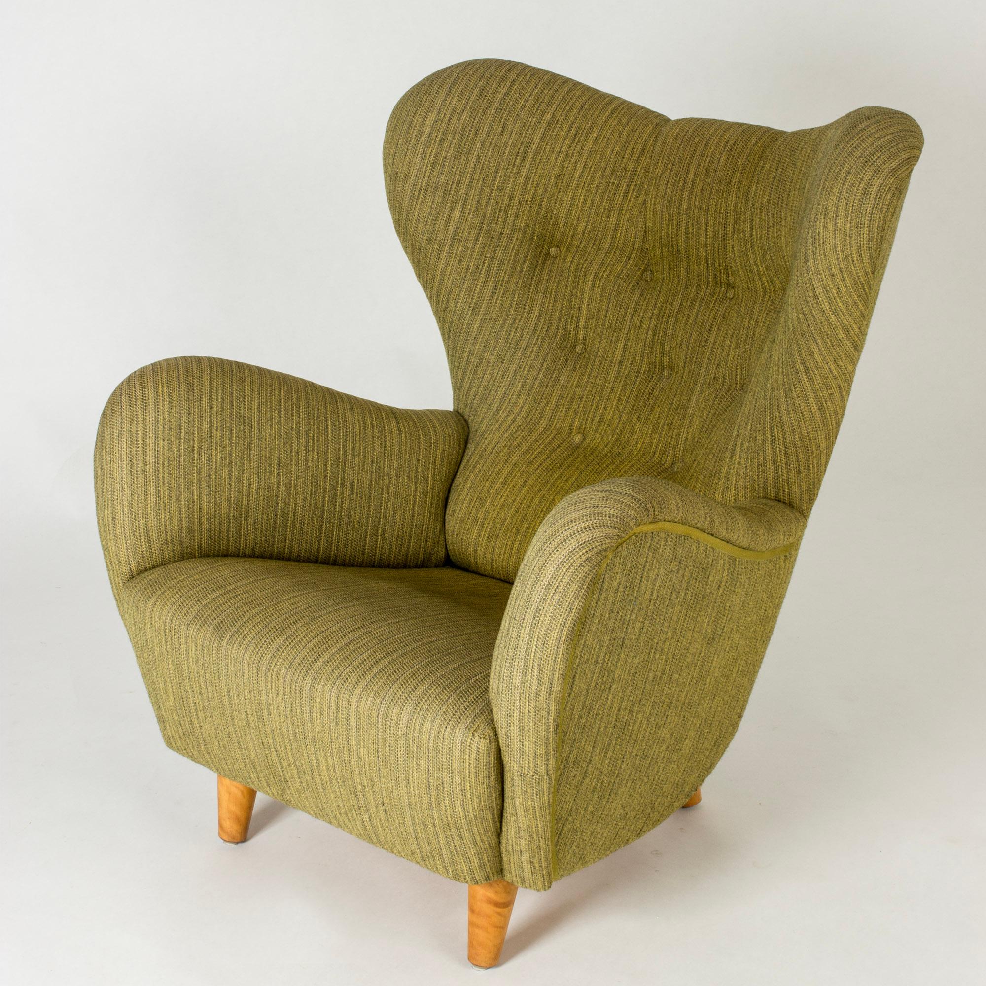 Elegant lounge chair by Otto Schulz in an oversized, ample design. Original green upholstery made from wool fabric.