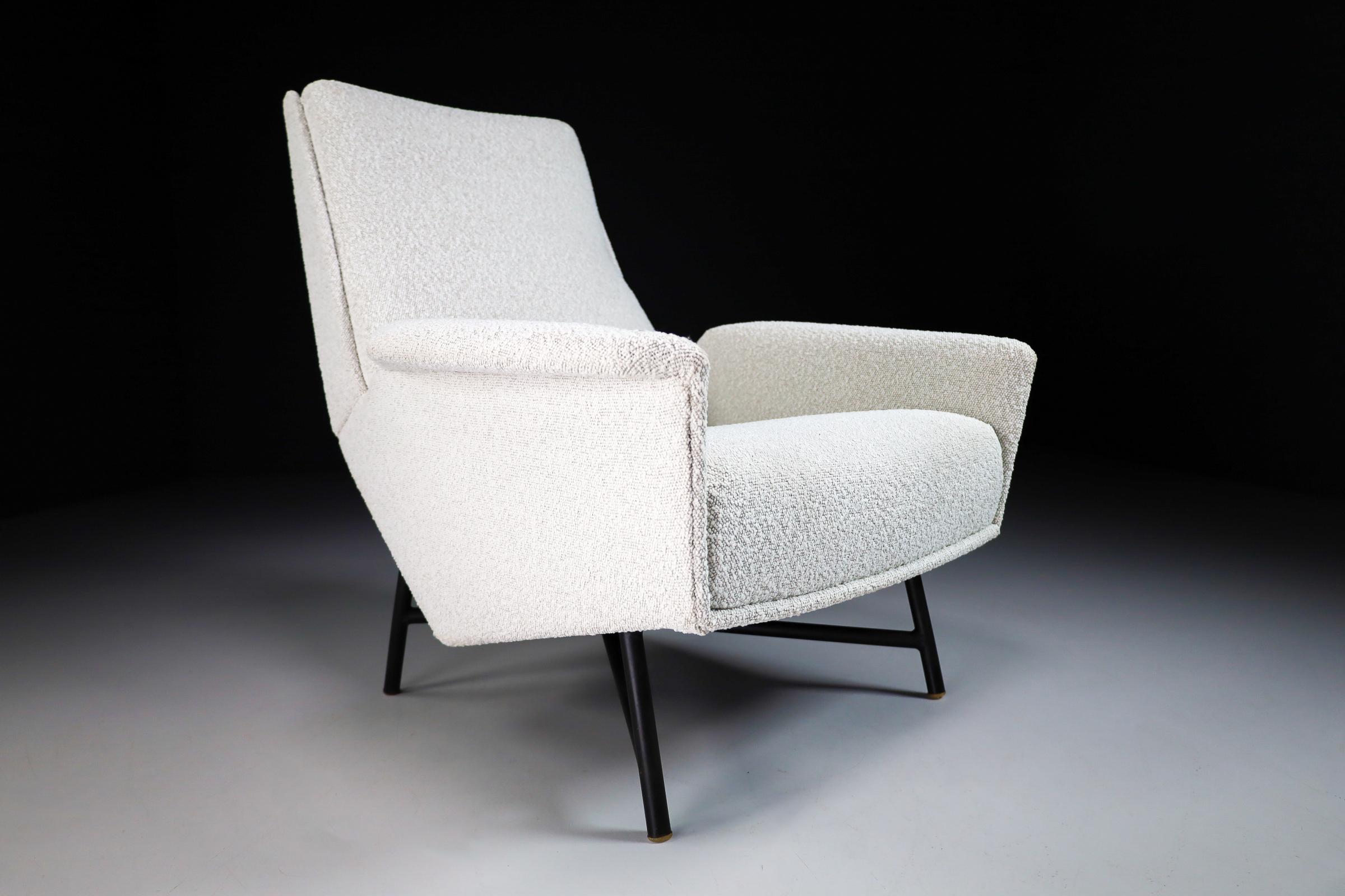 Mid-Century Modern lounge chair designed and edited by Guy Besnard in re-upholstered Boucle wool fabric, France, 1959. This armchair would make an eye-catching addition to any interior such as living room, family room, screening room or even in the