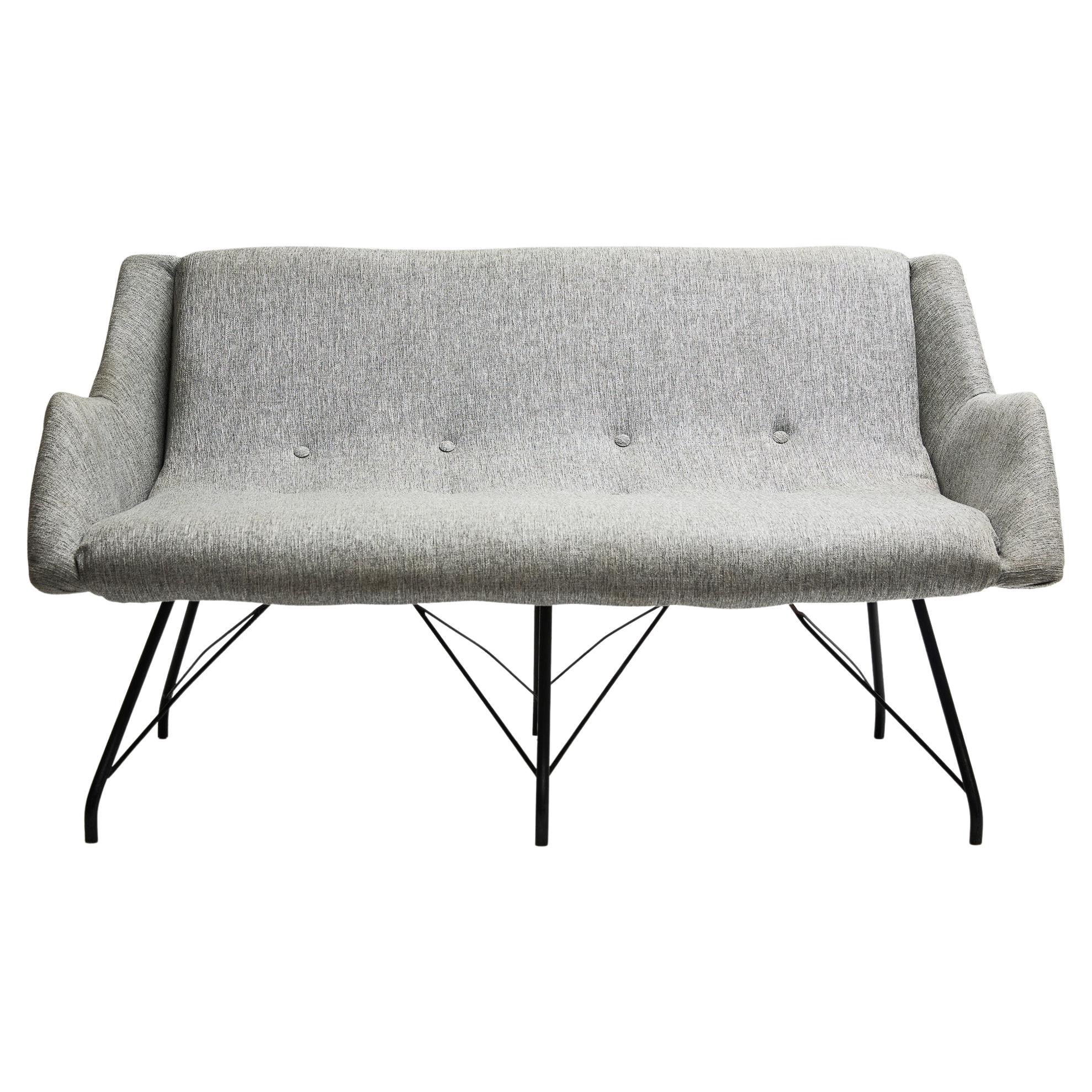 Available now, this Mid-Century Modern loveseat in grey cotton fabric & iron, was designed by Carlo Hauner and manufactured by Forma Moveis in Brazil 1955 and is a showstopper! The name of the model is “Concha” (“Shell” in Portuguese), as they