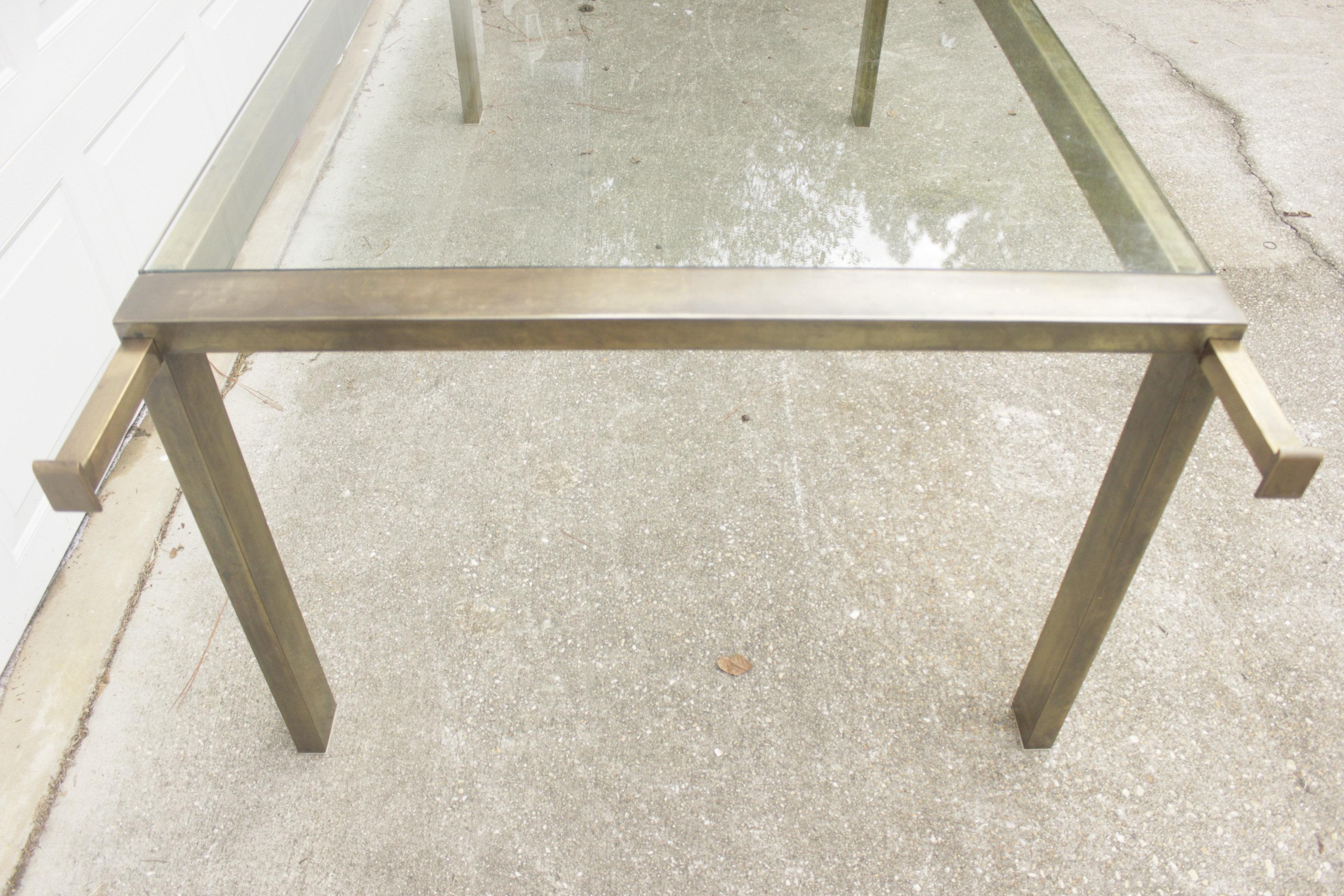 Stunning brass extension dining table by Mastercraft in the style of Milo Baughman. Heavy squared base and 1/2