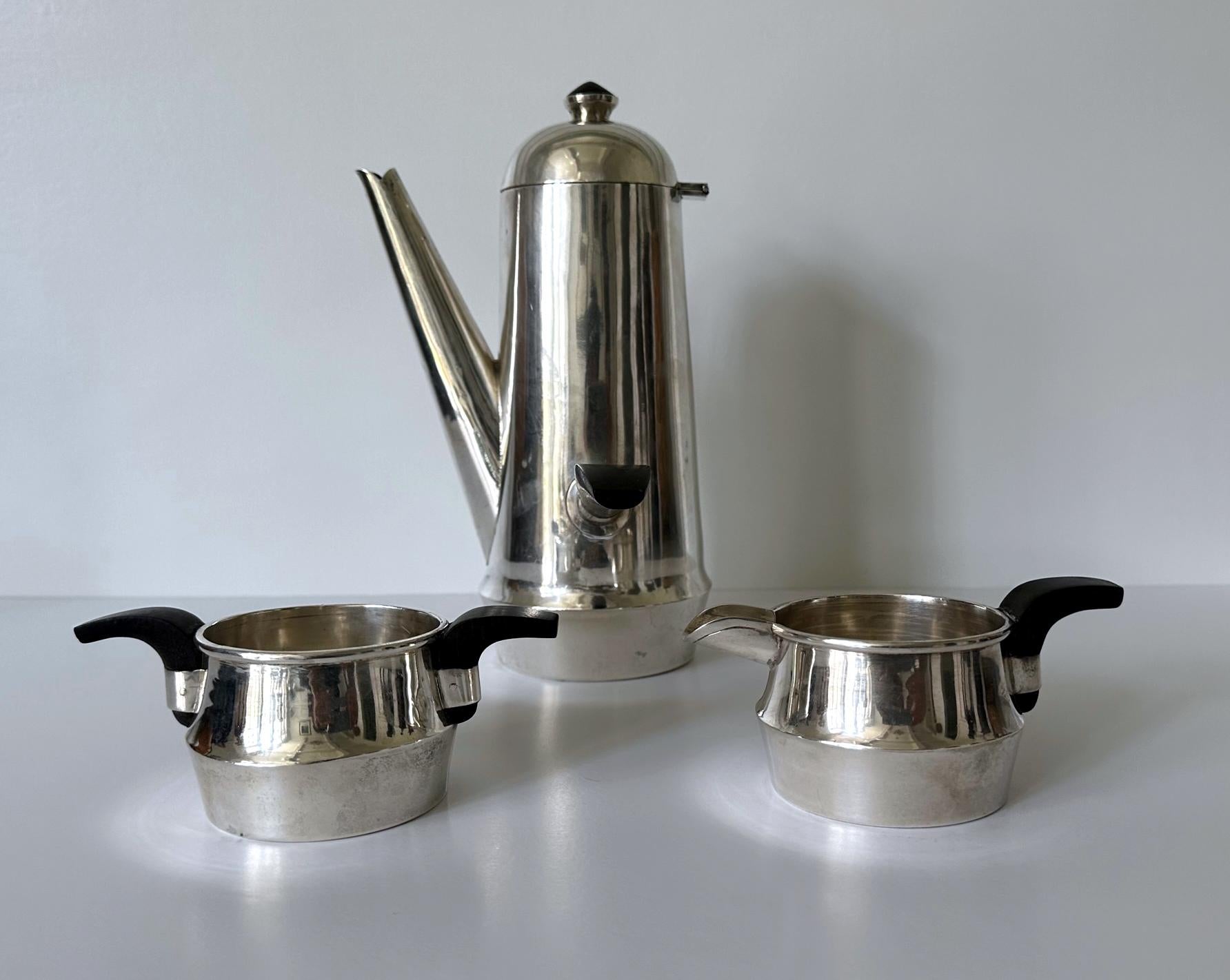 A lovely set of coffee service consisting of a large coffee pot, a sugar and a creamer (this set is of the largest size of this particular model we have seen so far). Made from sterling silver and ebony handles and knobs, the stylish mid-century