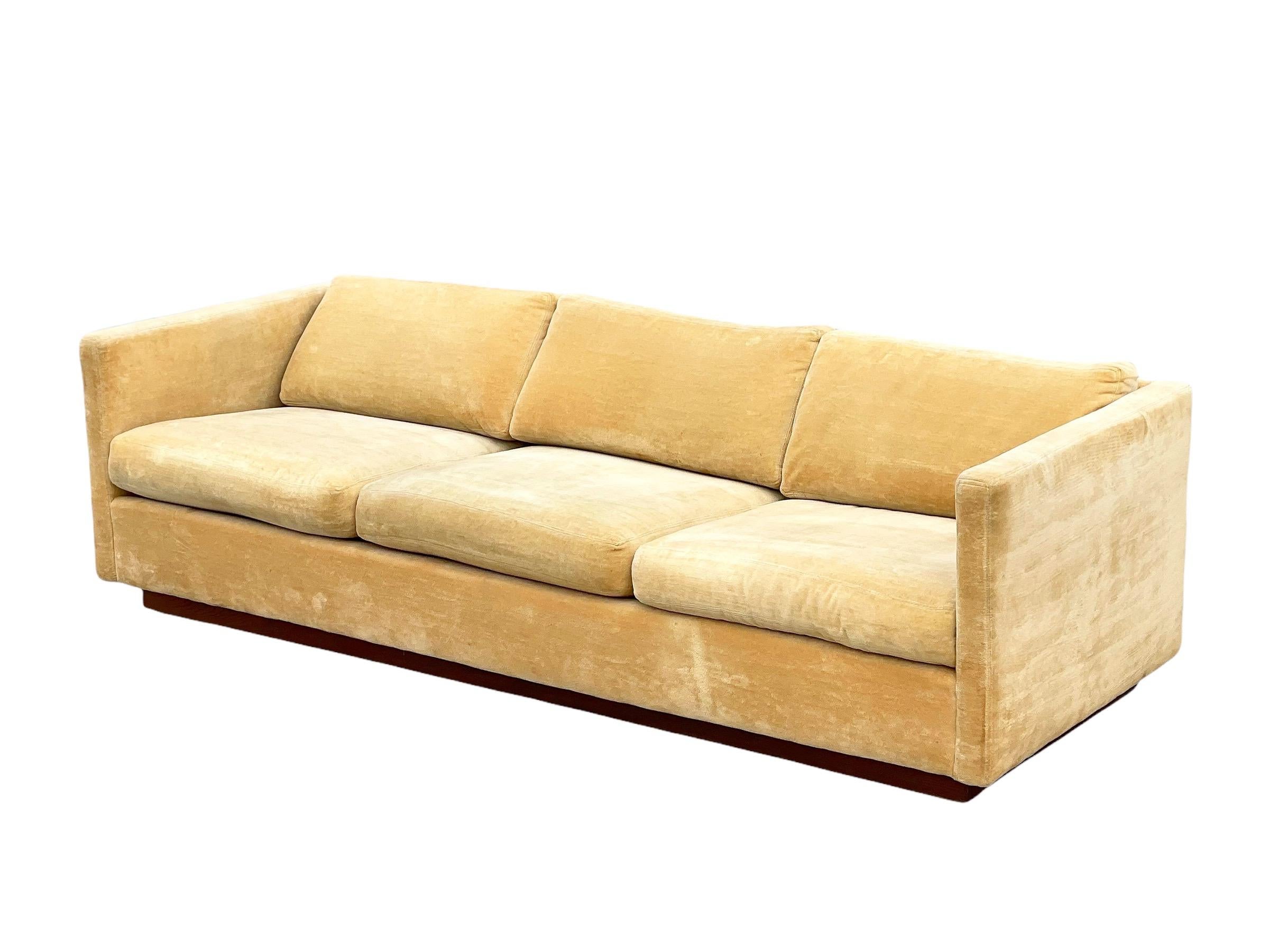 Stunning Mid-Century Modern Milo Baughman for Thayer Coggin tuxedo style sofa and loveseat living room set. Harvest gold velvet cushions and case atop a recessed walnut plinth base. Stout and sturdy American craftsmanship with clean modern lines.