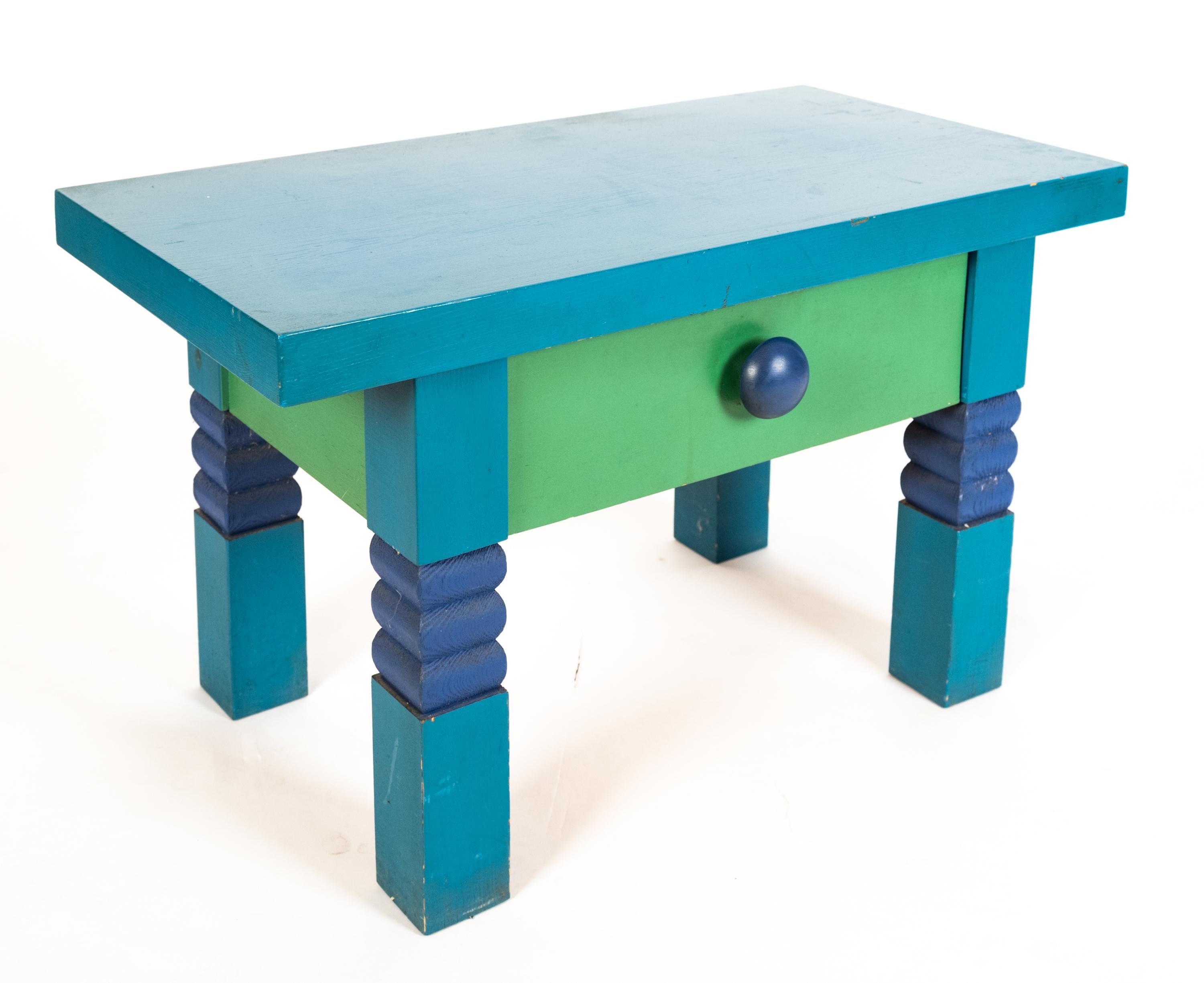 A Contemporary Century hall table and mirror by Swedish artist Erik Höglund (1932-1998) for Eriksmåla, Kosta Boda, 1967. Having a polychrome color scheme with a blue top resting upon four legs with carved dark blue rounded accents. Includes a green