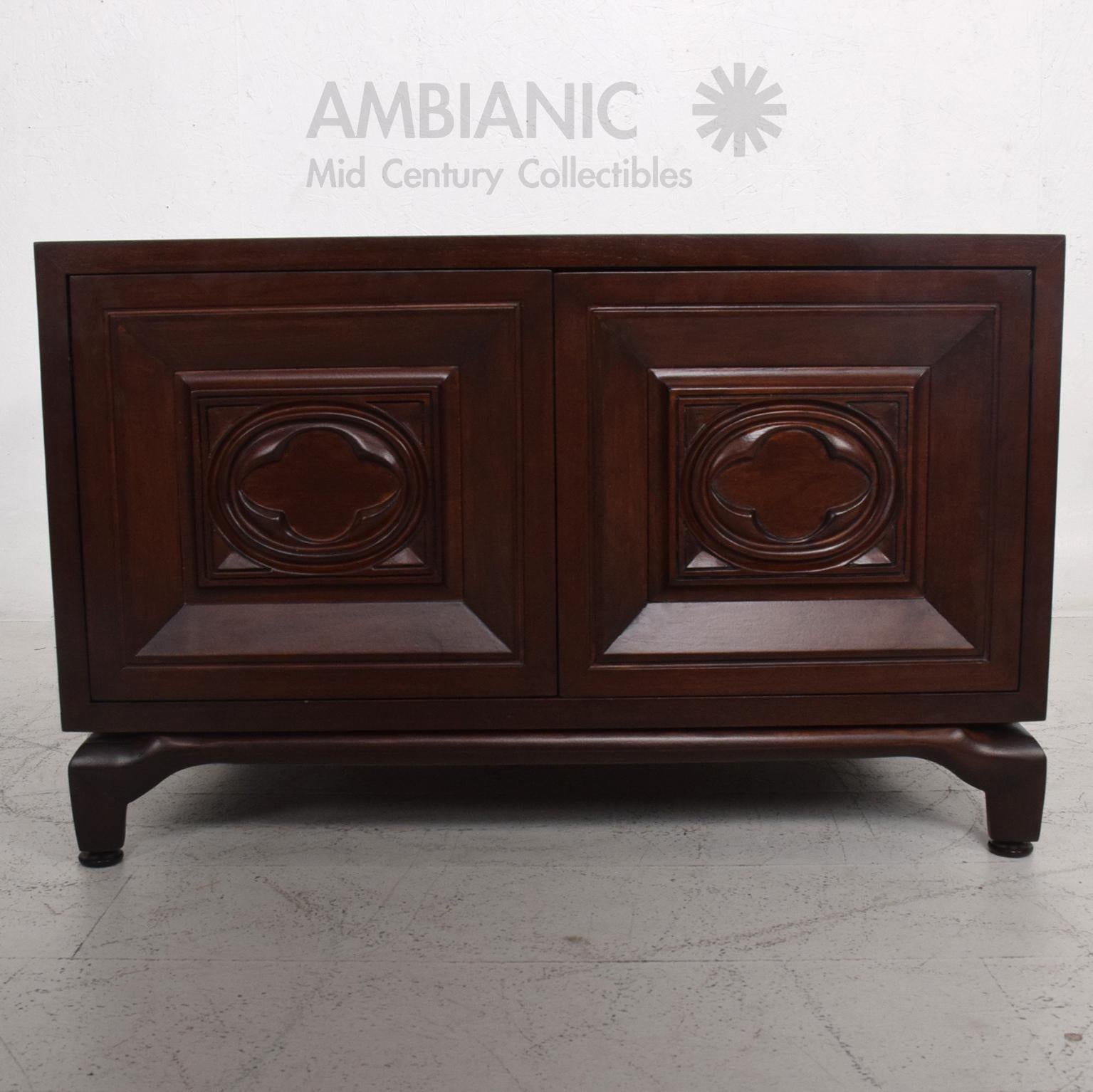 End Cabinets
1970s Monteverdi-Young carved mahogany cabinets side tables  
Push in magnetic lock system at doors
Designed in walnut mahogany. 
Sculptural carved wood detail on front door face. Subtle scroll outline at top.
Unmarked attributed to