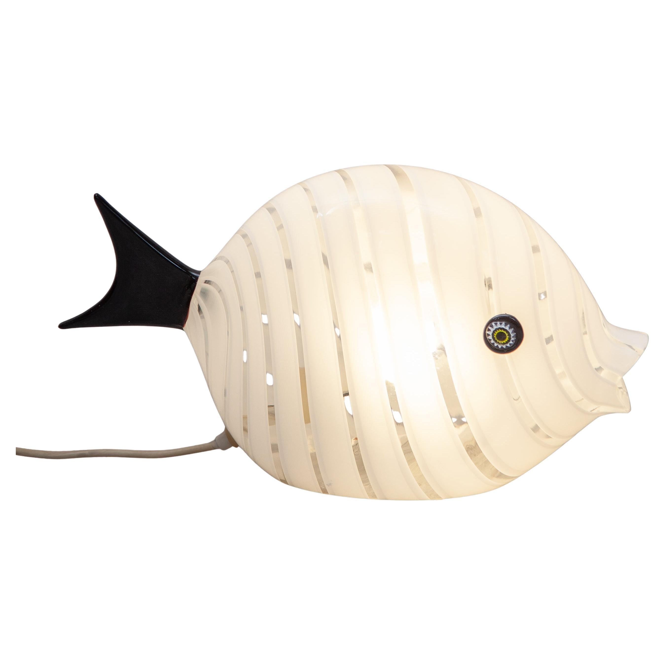 A beautiful sculptural glass object, mouth-blown in clear glass with white opaline stripes. The eyes are made of Murine glass paste. The fish lamp is an eye-catcher for any interior, office, or fish restaurant! 
