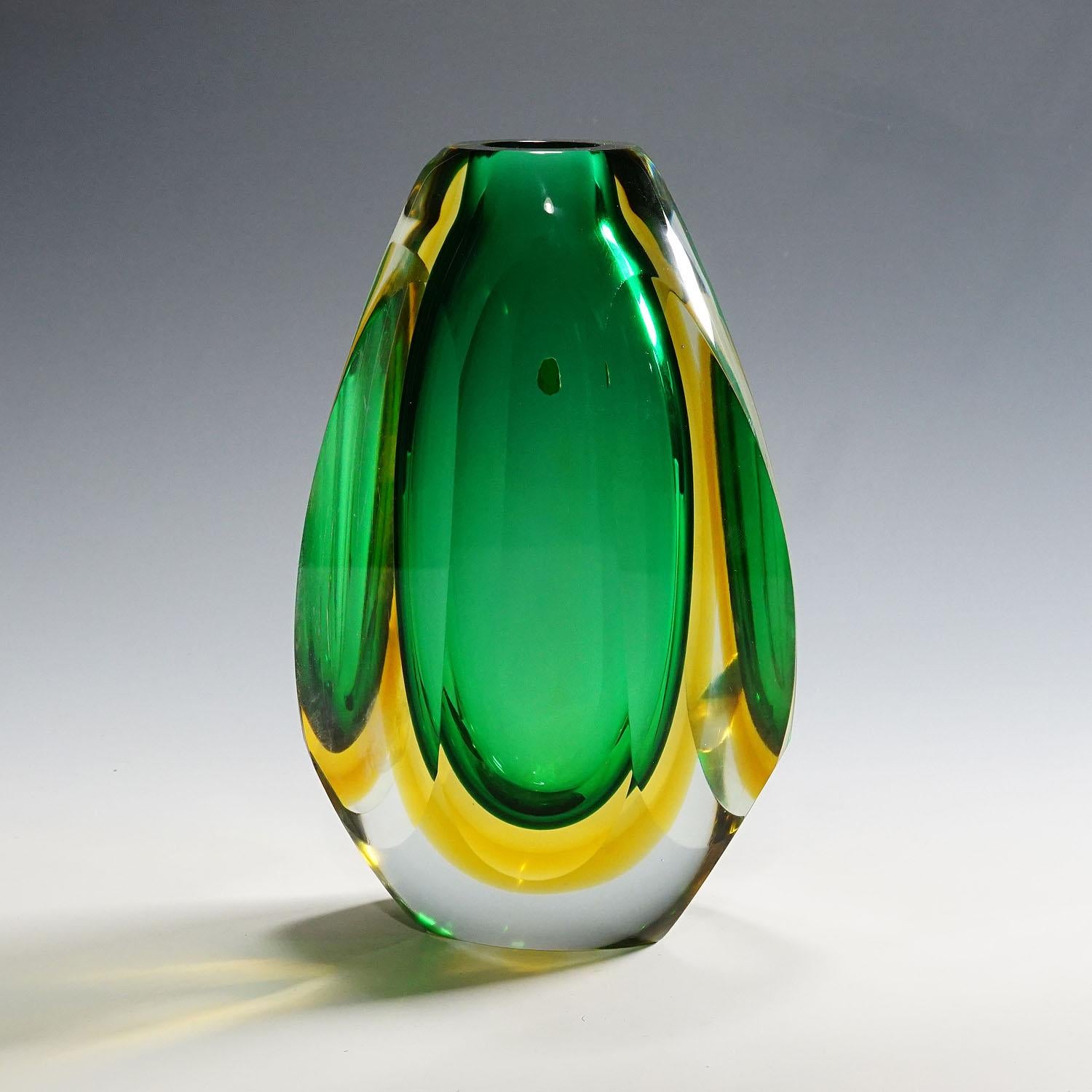 Midcentury Modern Murano Sommerso Art glass vase 1960s

A large and heavy Murano Sommerso glass vase most probably manufactured by Seguso Vetri d'Arte circa 1960s. Manufactured in green and yellow glass with a thick clear glass overlay. Each side