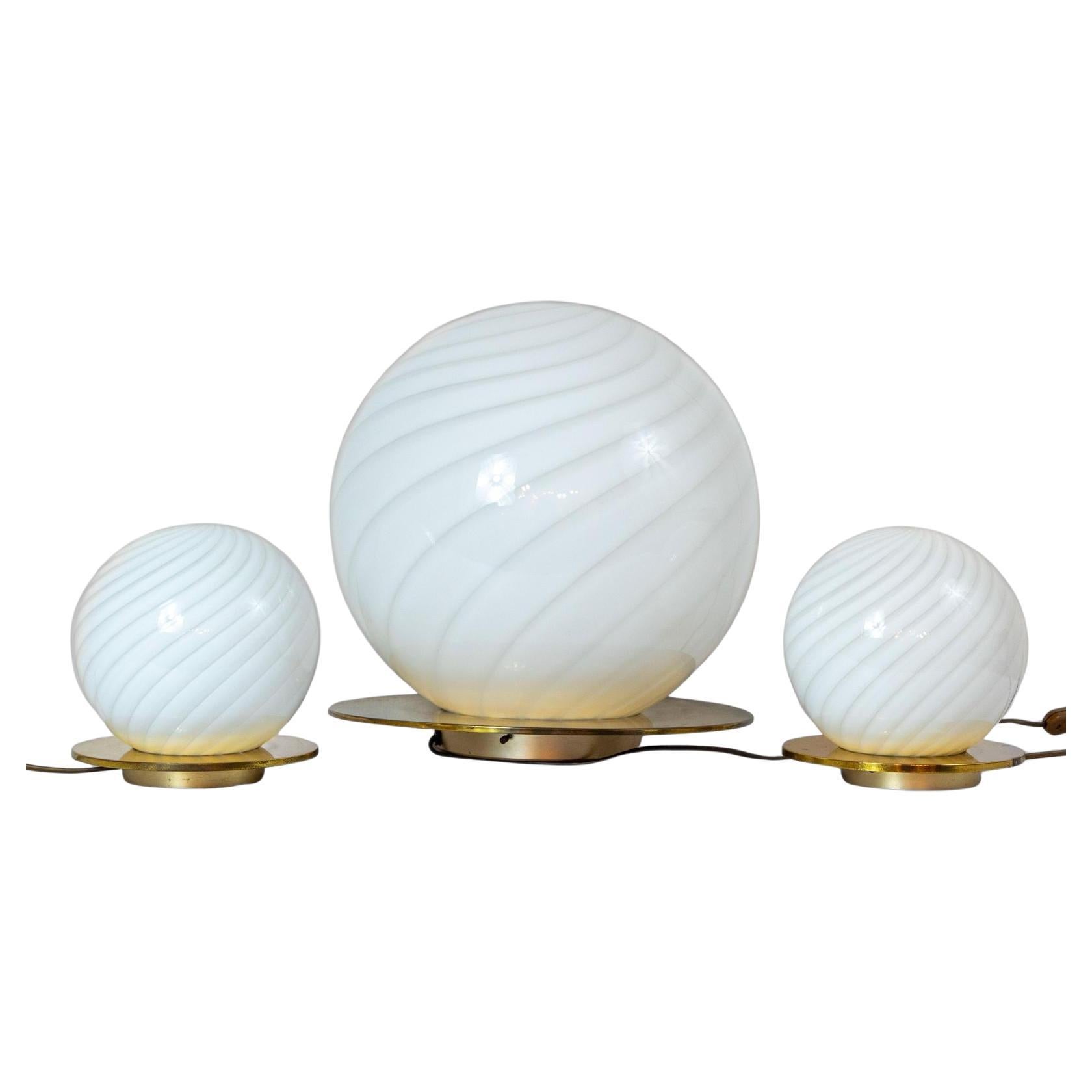 Set of Three Mid Century Modern Murano Table Lamps in the Style of Venini

Set of three Murano glass globe table lamps from the 1970s showcases Italian craftsmanship with a refined modernist aesthetic recalling the unique Venini Style. 

The