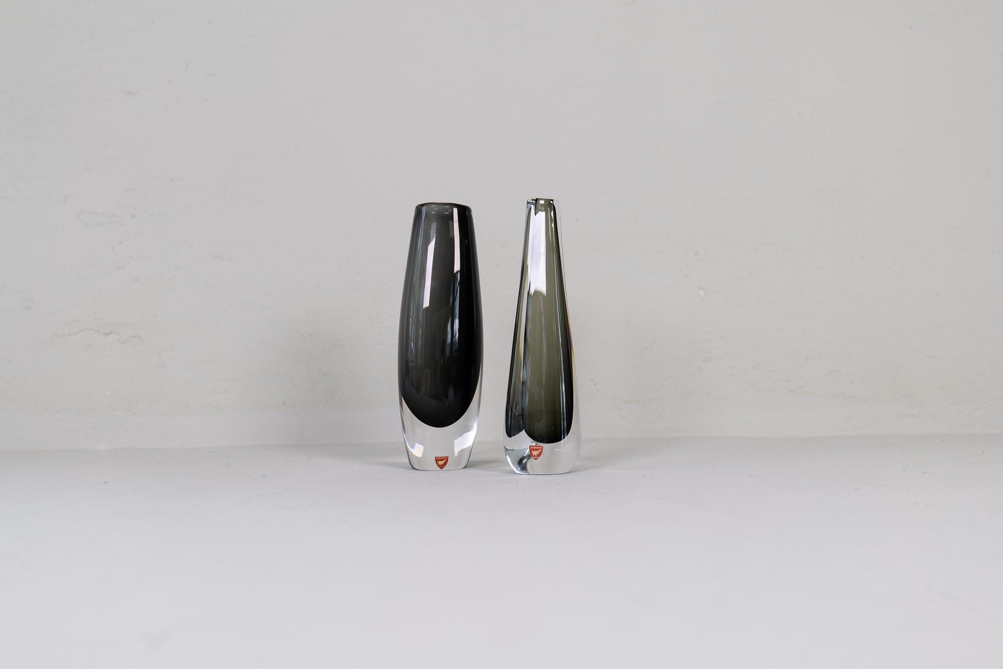 Art glass vases produced by orrefors , and designed by famous Nils Landberg.
Wonderful glass with exceptional color that collaborates with the clear glass. These two are a great looking pair. 

Good vintage condition with some