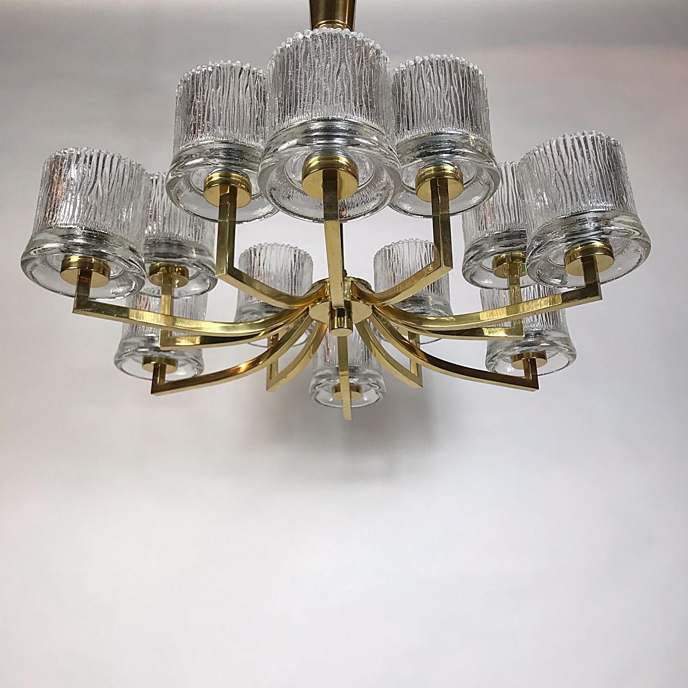 Huge beautiful Mid-Century Modern chandelier manufactured by Orrefors, with the characteristic blown ice glass cups and gold plated brass frame. This chandelier is a striking appearance in every room. Due to the sublime combination of glass and