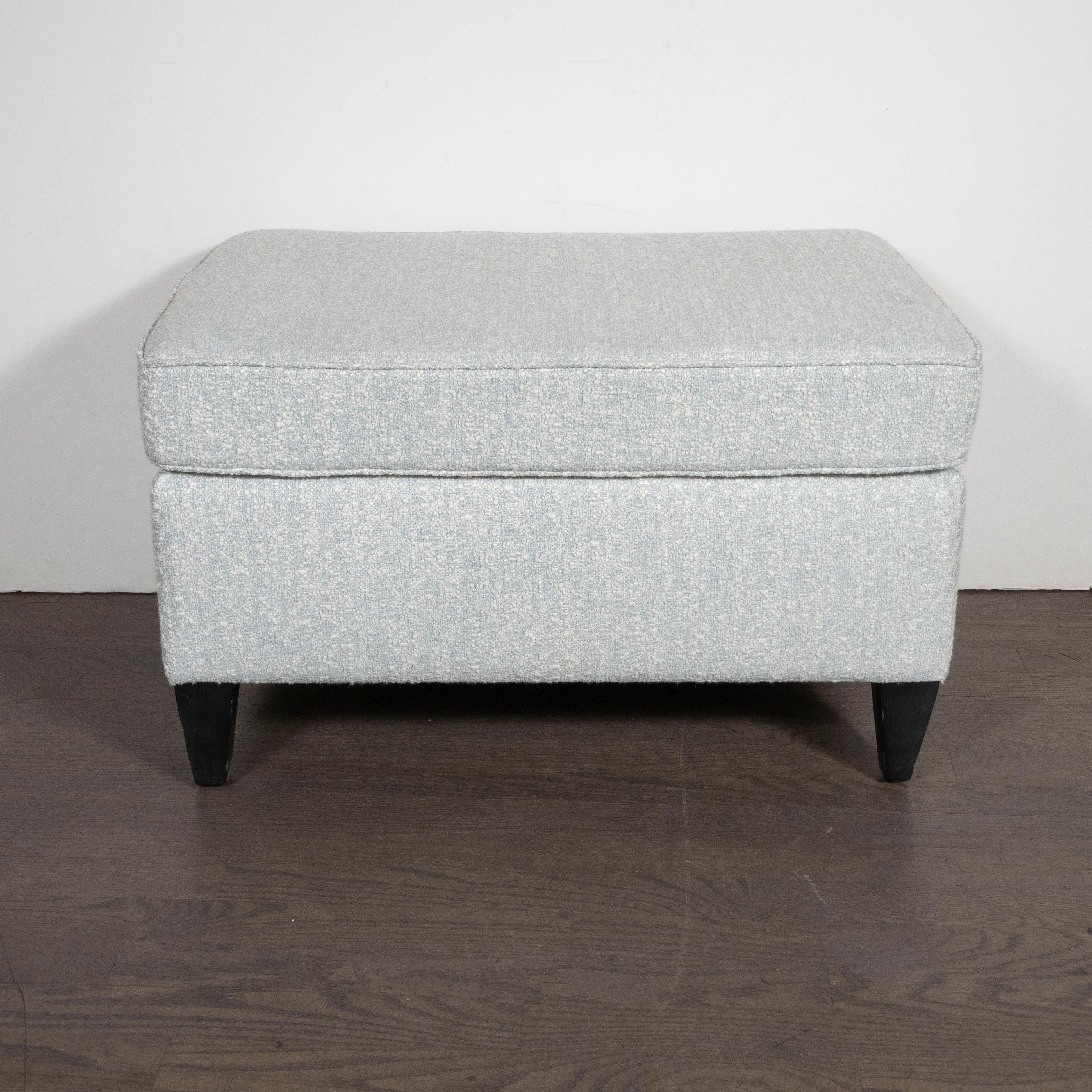 This refined and understated ottoman were designed by Paul McCobb- one of the most celebrated and influential figures in 20th century design- in America, circa 1950. The ottoman offers conical legs in ebonized walnut. McCobb once opined: “Design
