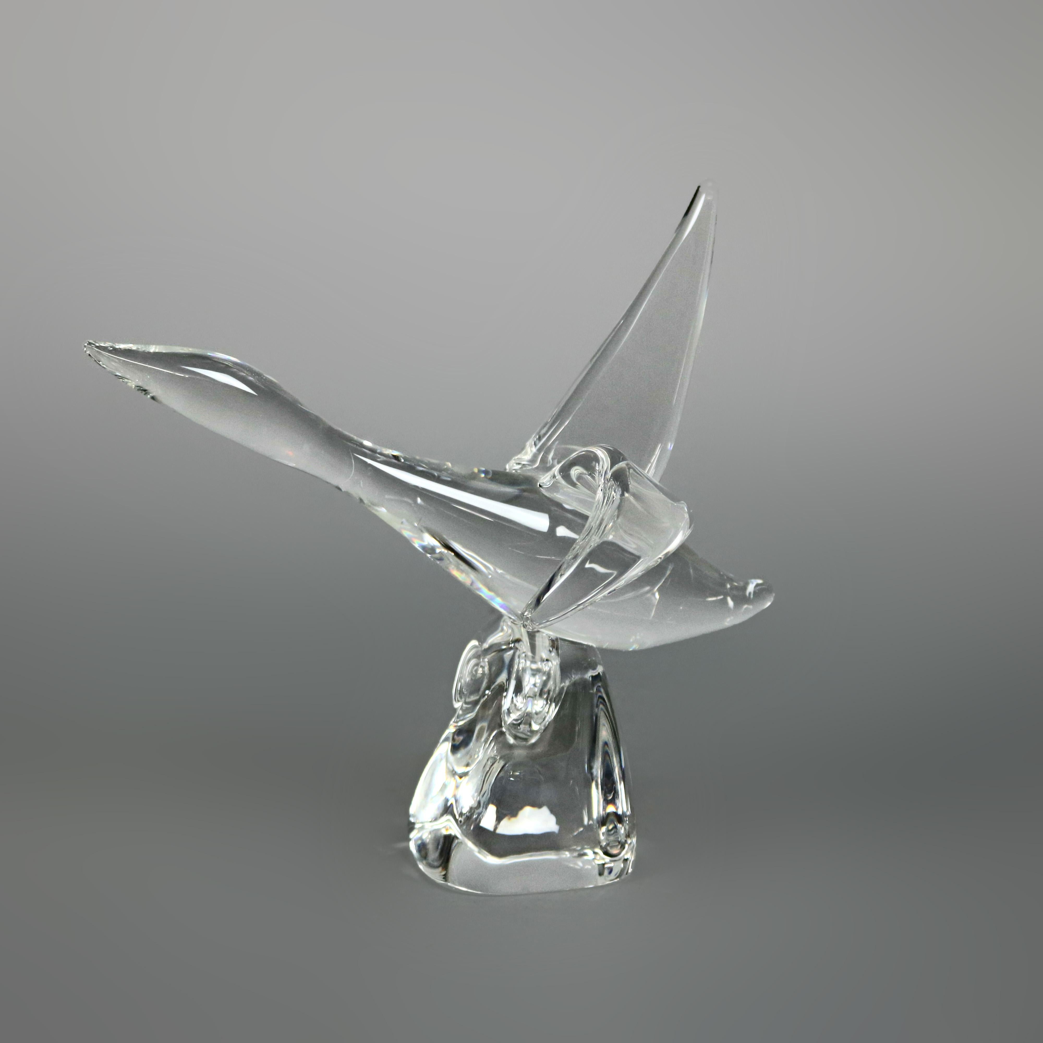 Midcentury Modern Steuben figurative mouth blown crystal sculptural paperweight features colorless art glass in full body form of a Canadian Goose in flight over wave, designed by Lloyd Atkins, 1960 for Corning Museum of Glass, New York, NY,
