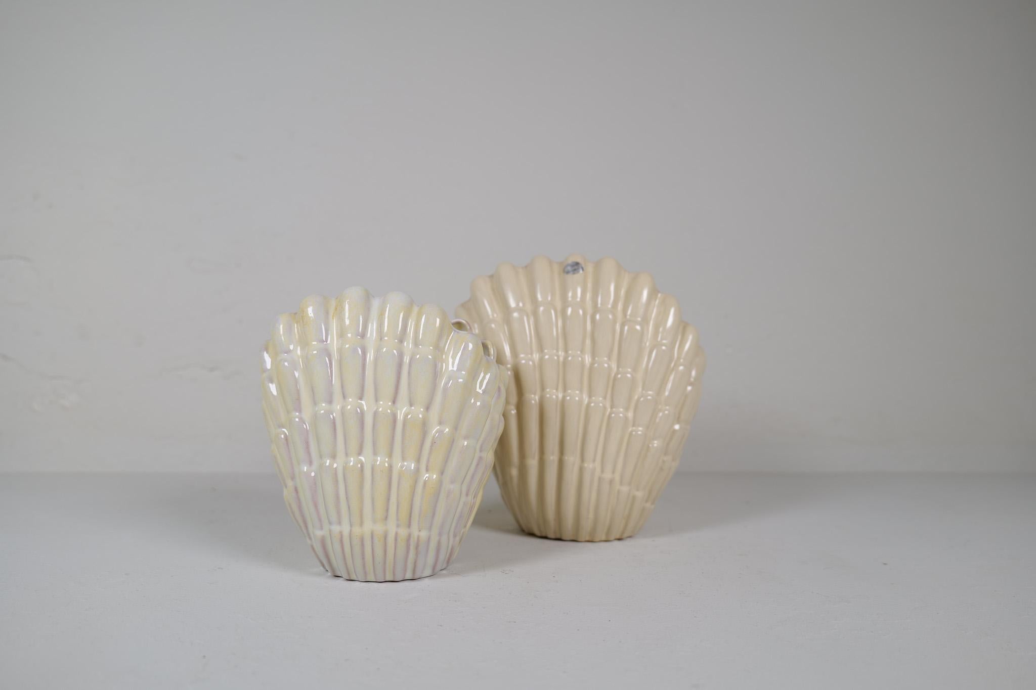 Seashell vases Designed by Vicke Lindstrand for Upsala Ekeby in Sweden during the 1940s. This pair gives a good impression and are a good example of the great craftmanship in Sweden during this time. One large and one smaller version of these vases.