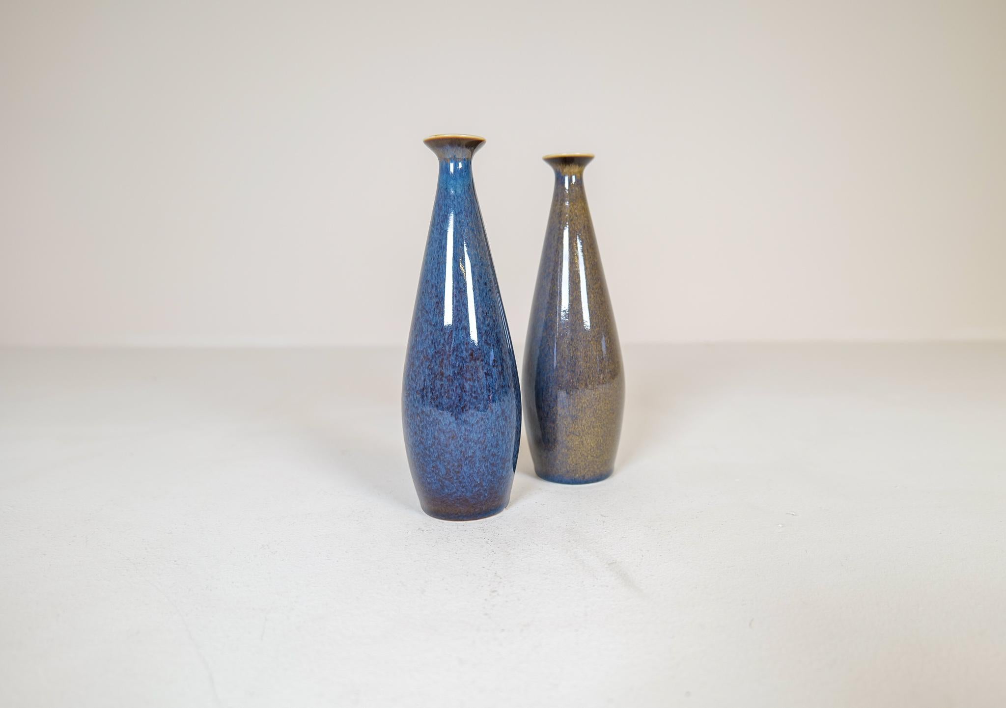 These vases from Rörstrand and maker/designer Carl Harry Stålhane, are a great example of midcentury modern quality and design made in Sweden during the 1950s and 1960s. The sculptural shape together with the amazing glaze this pair is a wonderful