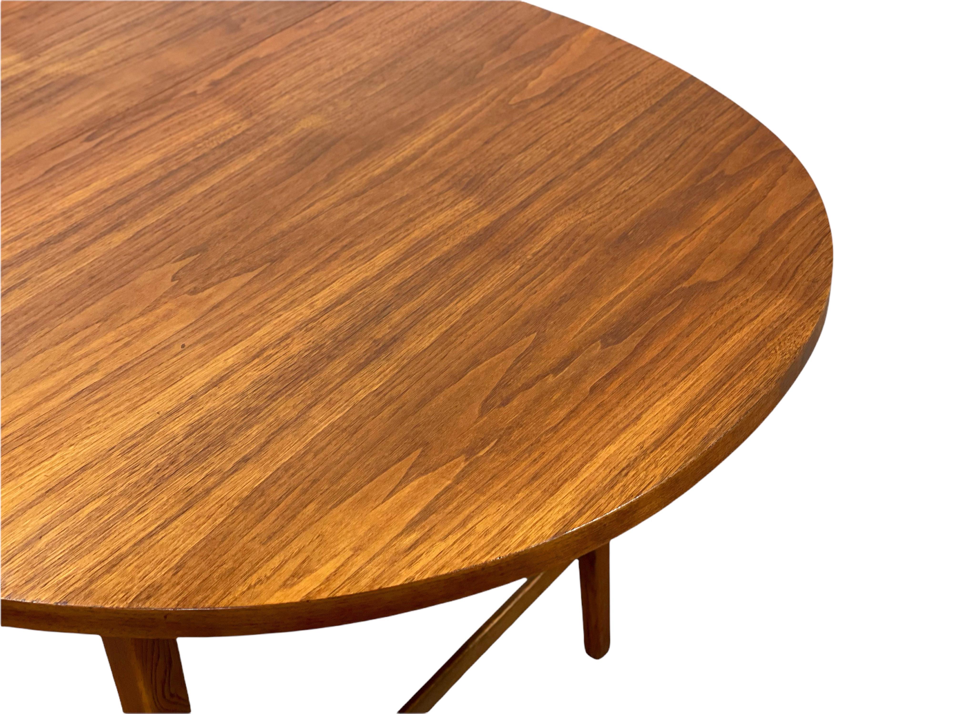 Rare walnut oval draw leaf dining table by Paul McCobb for his Components line. Seldom seen, this example is unique on the market. Similar to the Connoisseur line in design and dimensions, the Components tables features solid walnut cross stretchers