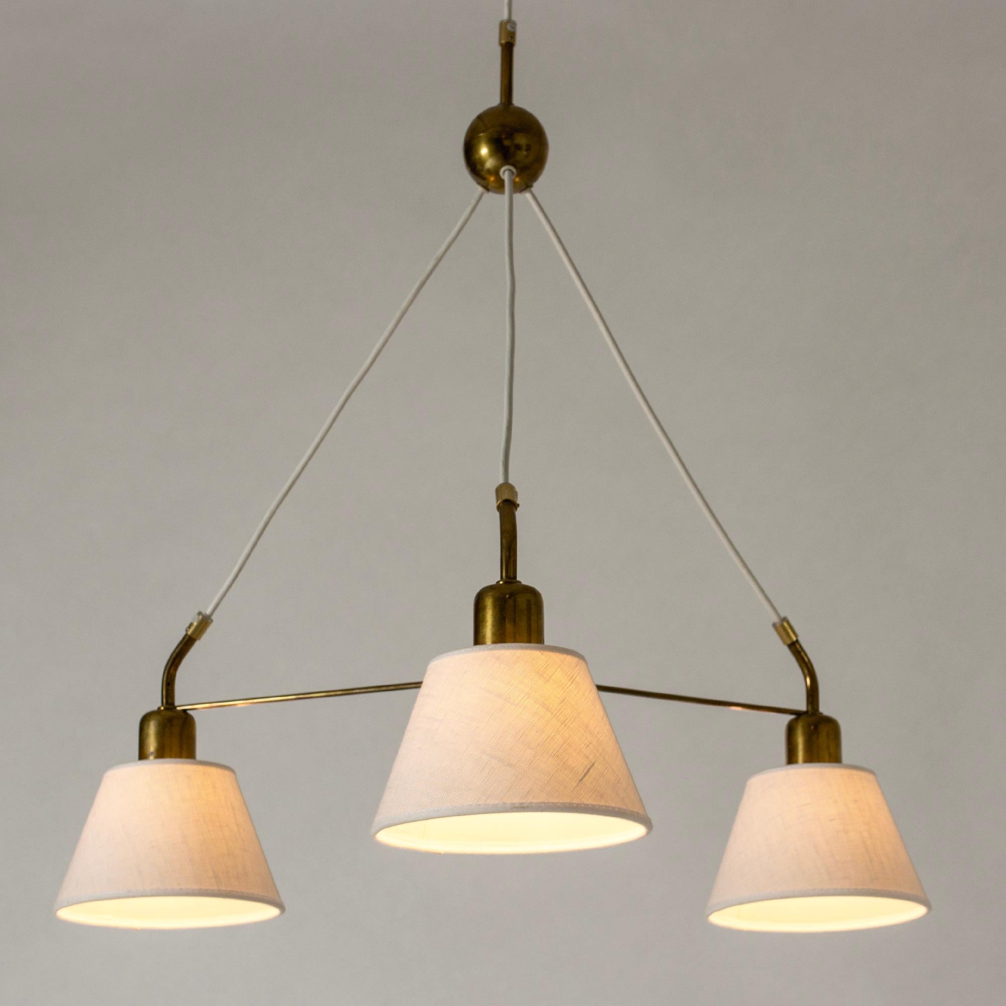 Elegant brass pendant light by Josef Frank, with three shades. Slender brass frame and decorative brass ball on the chord.

Length of chord is adjustable according to preference.