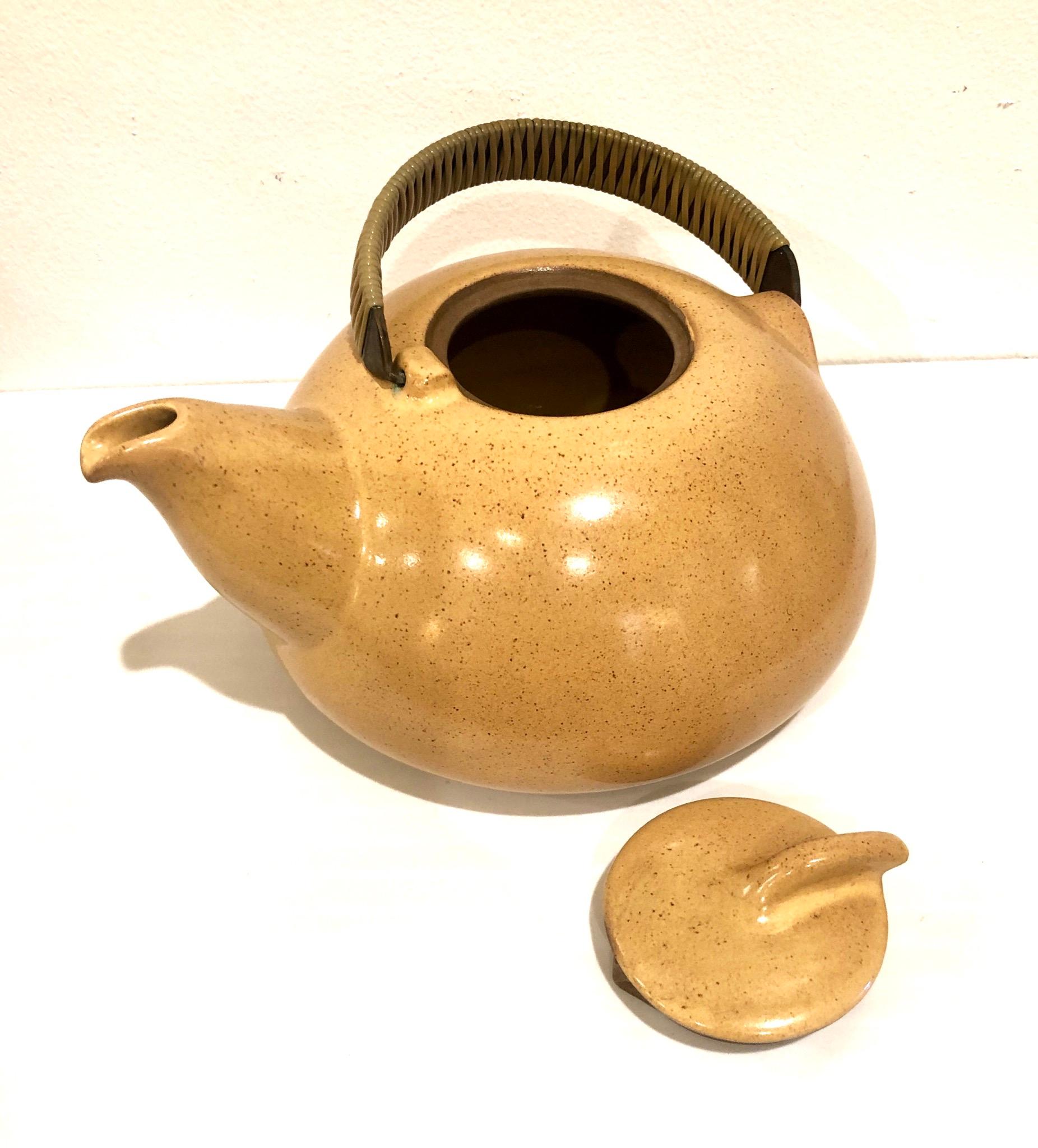 Beautiful and rare teapot design by Heath Ceramics of San Francisco California nice lines ceramic piece with copper handle wrapped no chips or cracks and beautiful color.