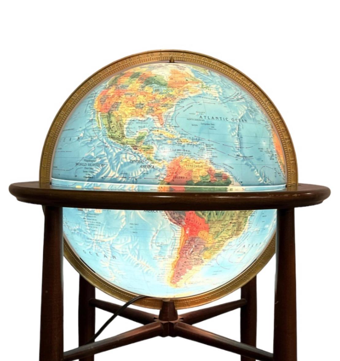 Light up world globe by Replogle. Signed and guaranteed authentic. Attractive with or without globe being illuminated. Simple elegant modernist lines on solid wood frame. In good condition with age appropriate appearance. Great color to the globe