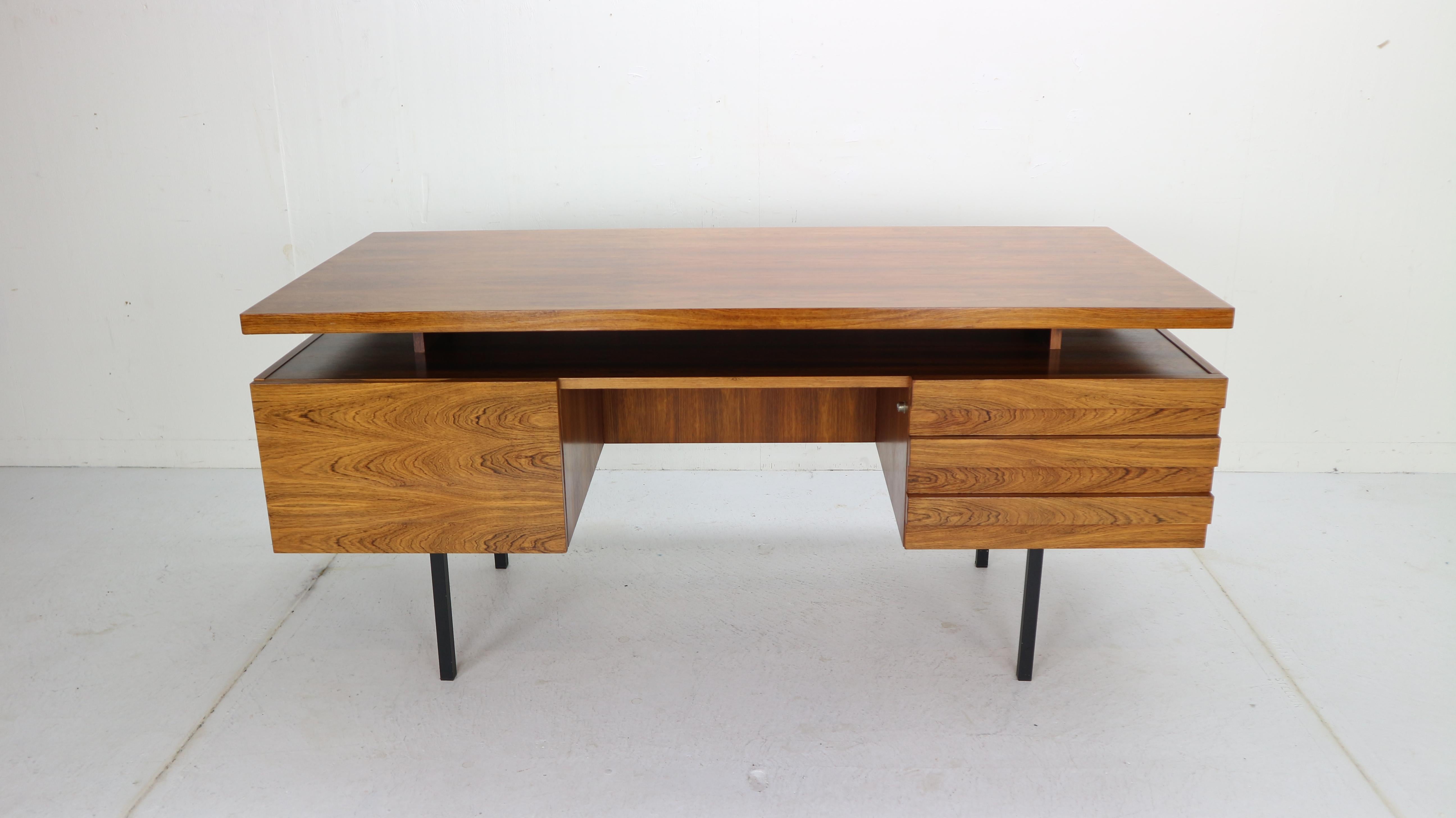 Mid-Century Modern period writing table-desk designed by Leo Bub for Wertmöbel in 1960s, Germany.
Exclusive desk is made of rosewood with minimalistic black metal feet.
The desk features one lockable compartment, drawers and several shelves at the